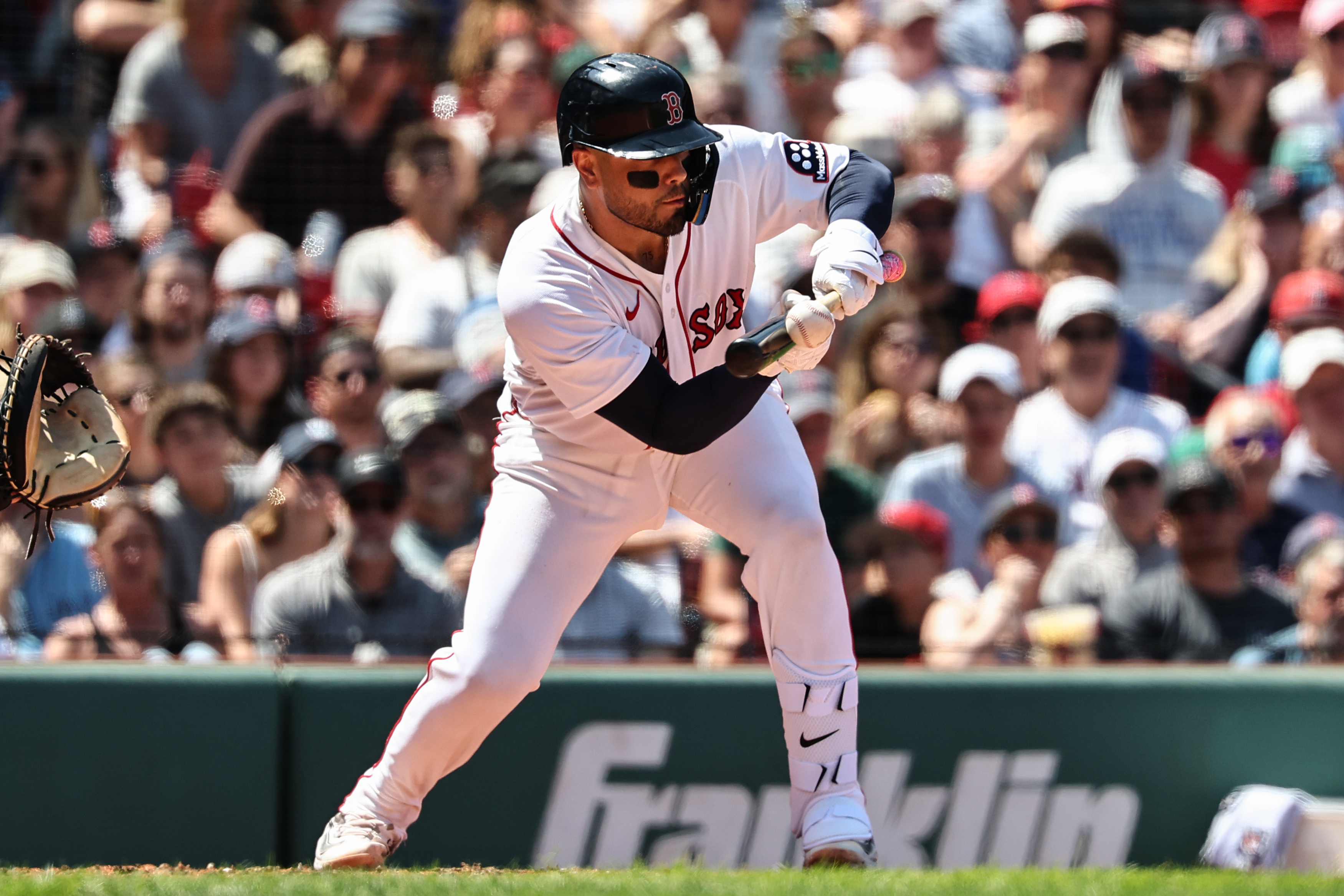 Carlos Narváez #75 of the Boston Red Sox lays down a sacrafice bunt against the Toronto Blue Jays during the third inning at Fenway Park