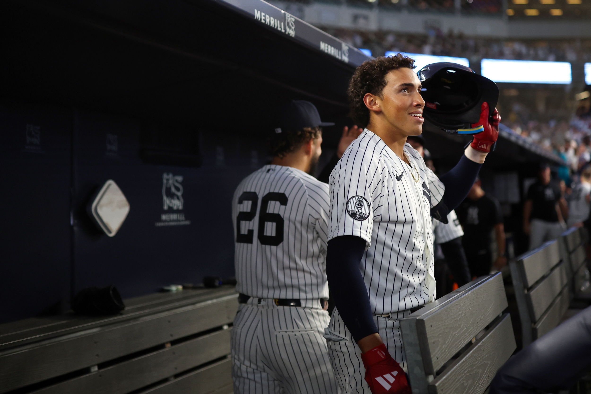 George Lombard Jr. smiles in the Yankees dugout.