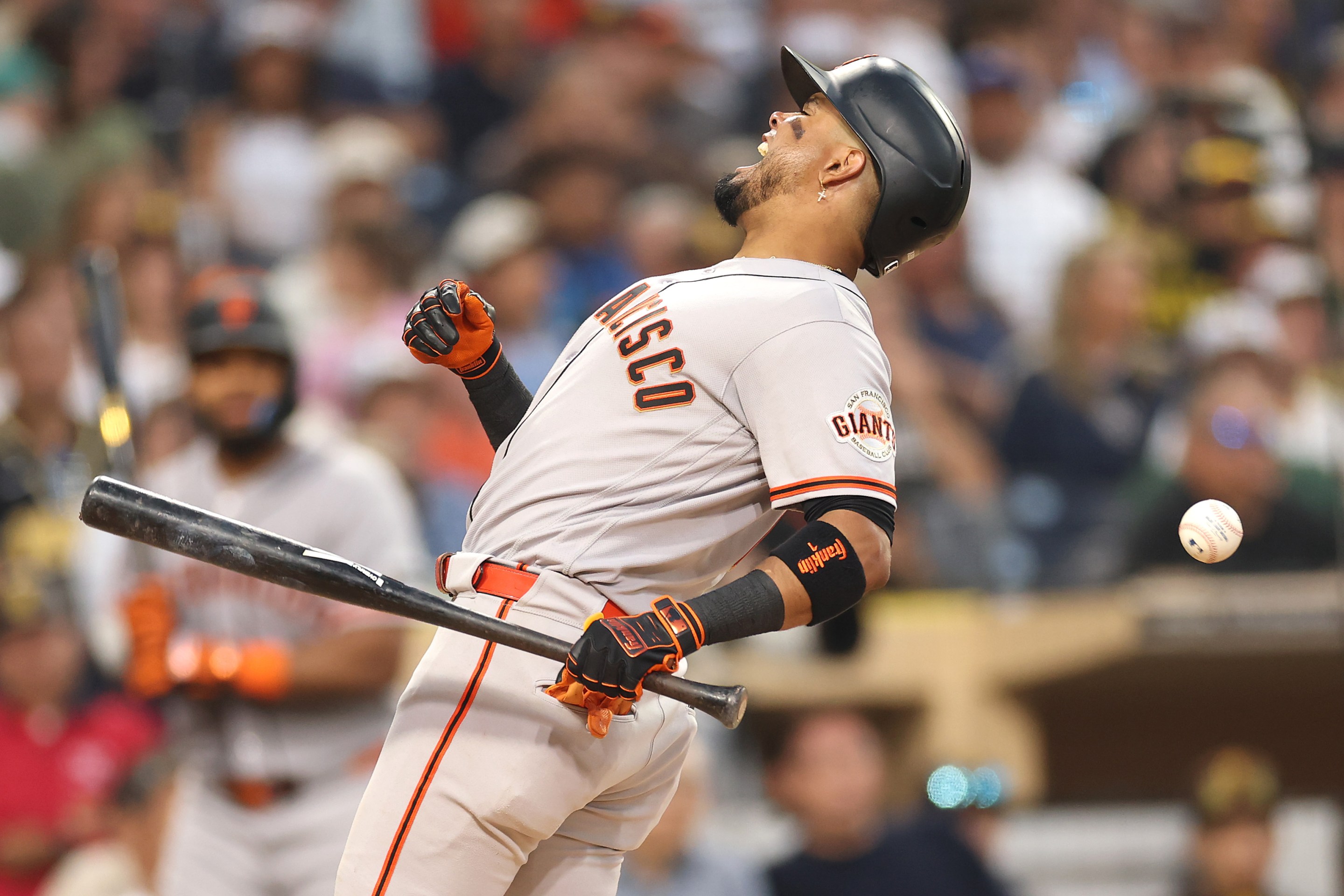 Luis Arraez of the San Francisco Giants is hit by a pitch during the fourth inning of a game against the San Diego Padres at Petco Park on July 30, 2026 in San Diego, California.
