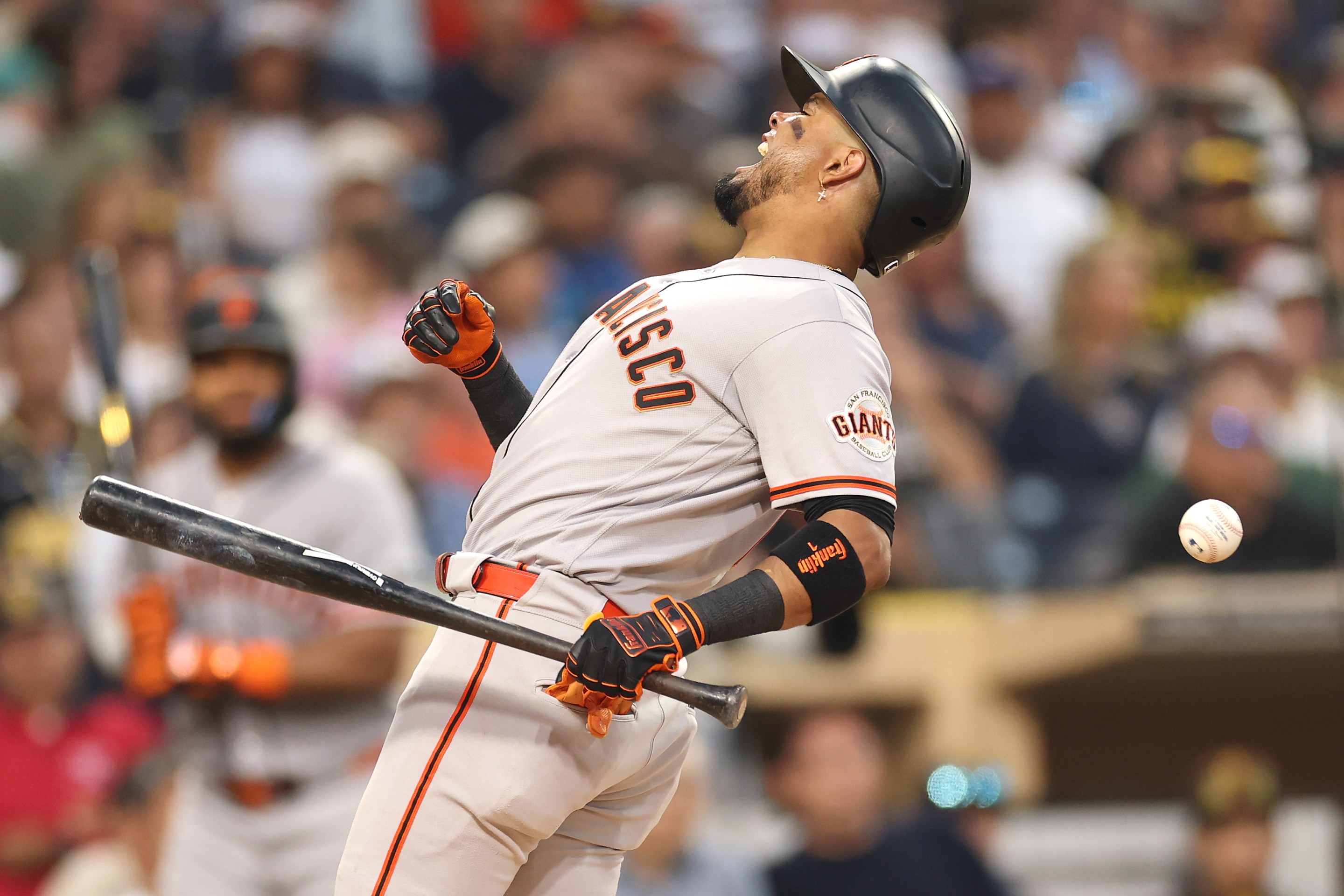 Luis Arraez of the San Francisco Giants is hit by a pitch during the fourth inning of a game against the San Diego Padres at Petco Park on July 30, 2026 in San Diego, California.