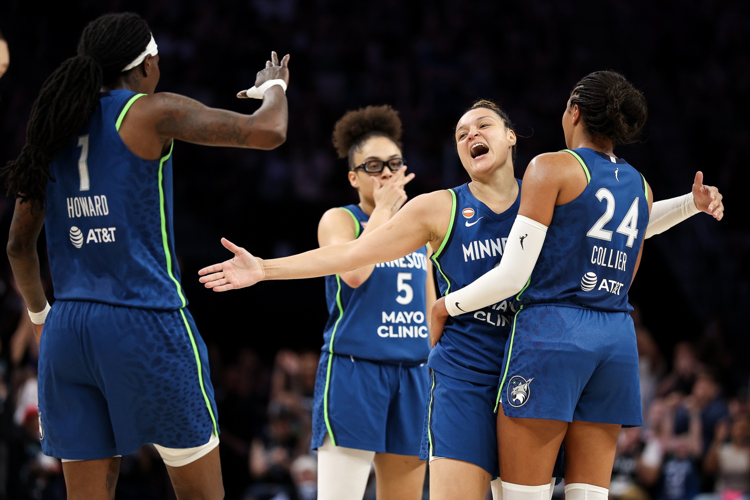 Kayla McBride #21 of the Minnesota Lynx celebrates a three-point basket with Napheesa Collier #24 and teammates during the second half against the Dallas Wings at Target Center on August 9, 2026 in Minneapolis, Minnesota.