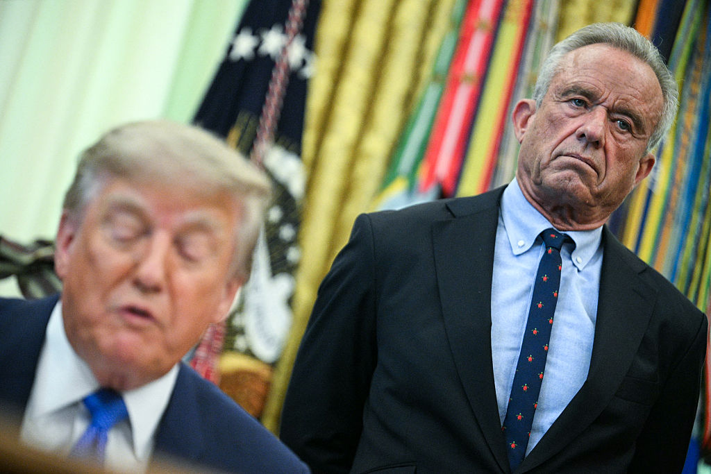 US Secretary of Health and Human Services Robert F. Kennedy Jr. (R) looks on as President Donald Trump speaks before signing an executive order