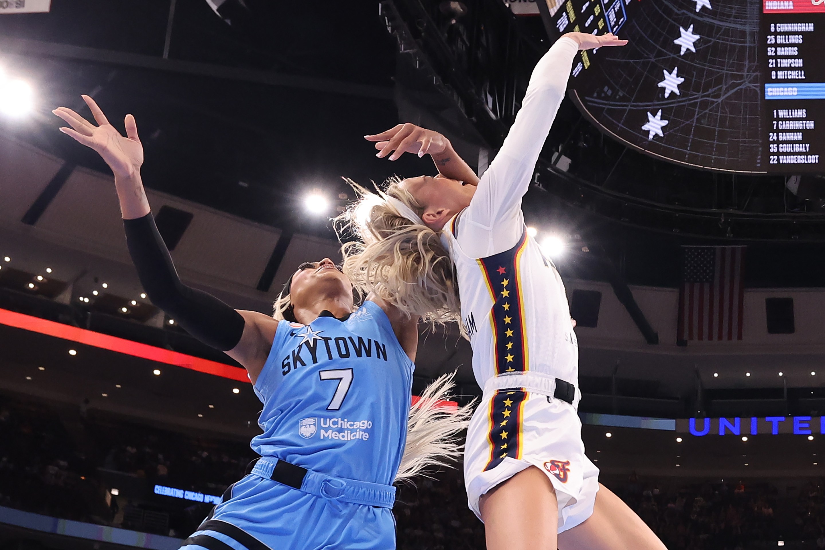Sophie Cunningham #8 of the Indiana Fever is fouled by DiJonai Carrington #7 of the Chicago Sky during the first half