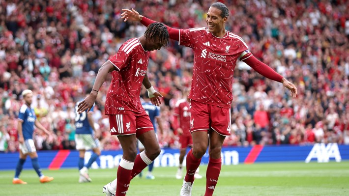 Jeremy Jacquet of Liverpool celebrates scoring his team’s second goal with teammate Virgil van Dijk during the pre-season friendly match between Liverpool FC and Como Calcio at Anfield on August 16, 2026 in Liverpool, England.