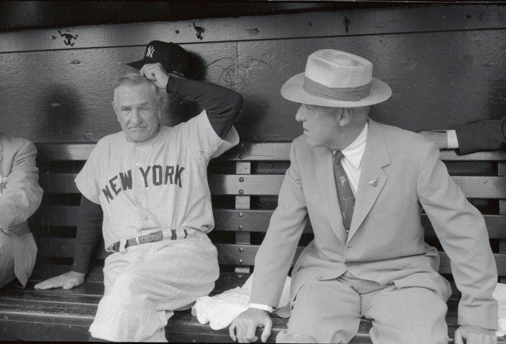 (Original Caption) American league All-Star manager Casey Stengel and newly re-elected baseball commissioner Ford Frick chat in dugout as American League team readied to take field for 24th annual All-Star game here 7/9.