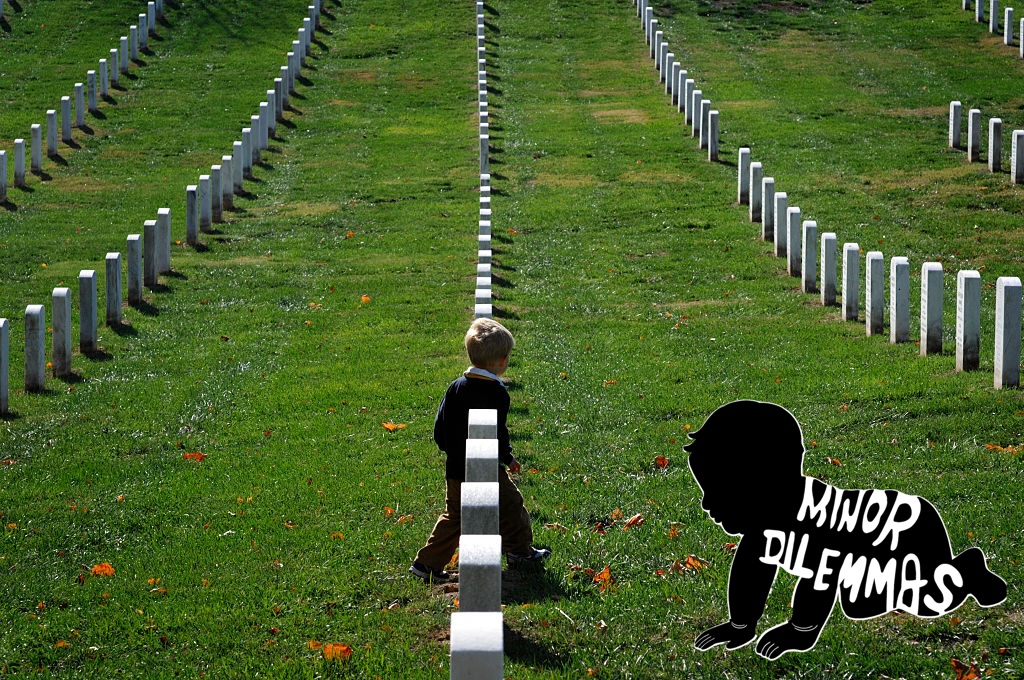 A little boy walks among the tombstones at Arlington National Cemetary in Washington D.C.