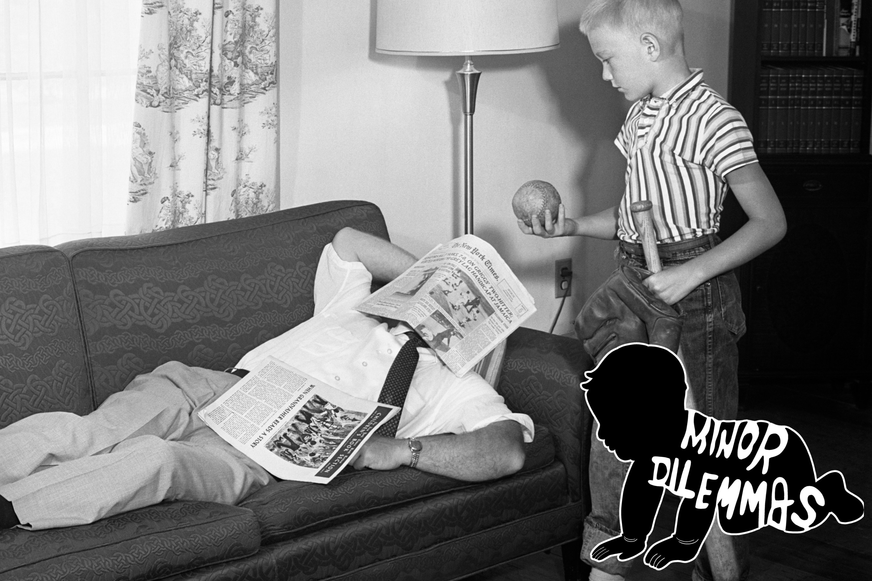 1950s FATHER LYING ON A SOFA WITH NEWSPAPER OVER HIS HEAD WHILE SON IS STANDING OVER HIM WITH BAT BALL AND BASEBALL GLOVE (Photo by D. Corson/ClassicStock/Getty Images)