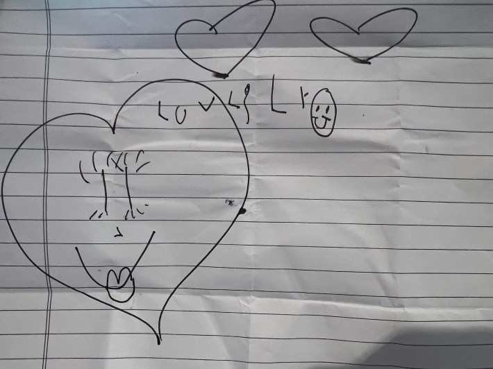 Some hearts and a smily face drawn by an almost-six-year-old. It says "love Lily."