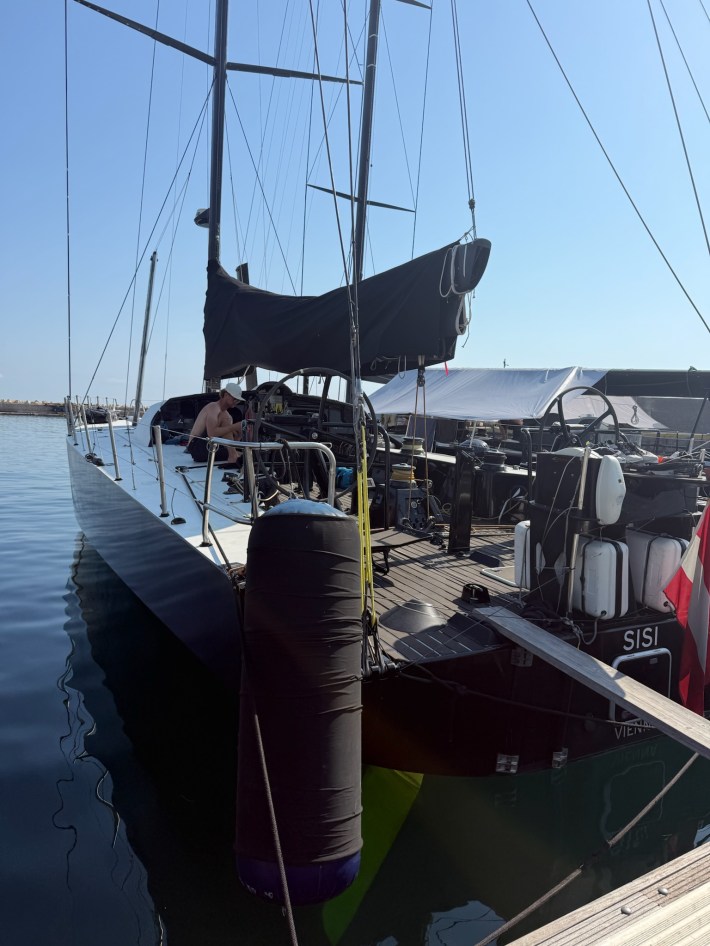 Sisi is docked at Palermo, with one crew-member sitting on deck.