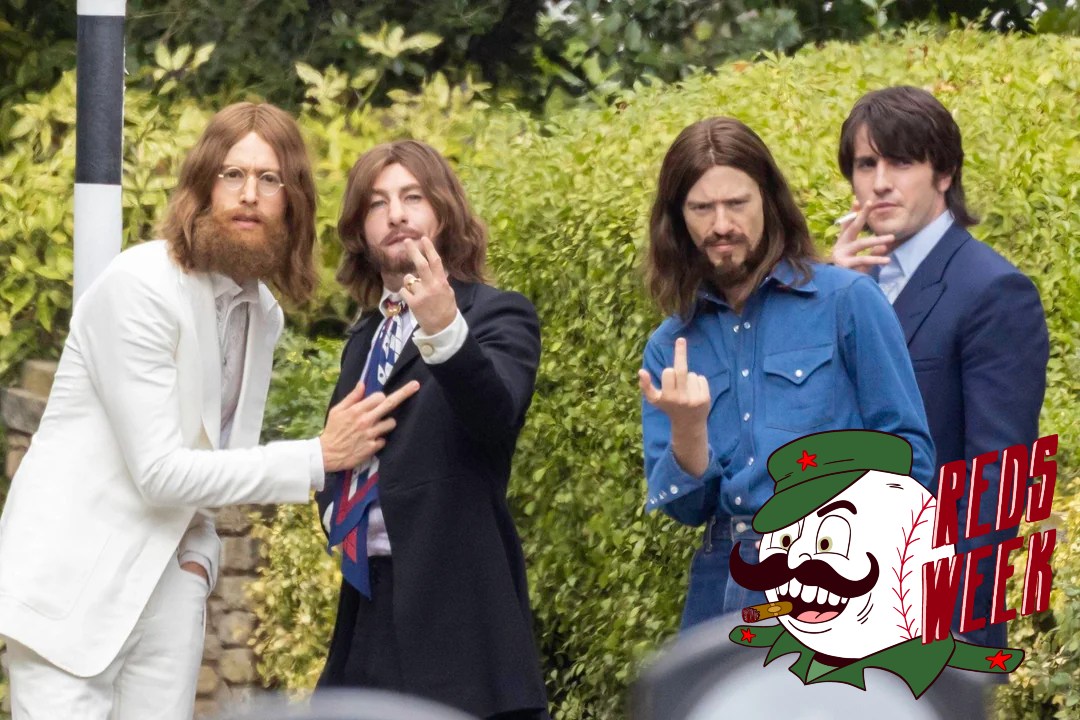 four actors in bad Beatles wigs pose for a photo