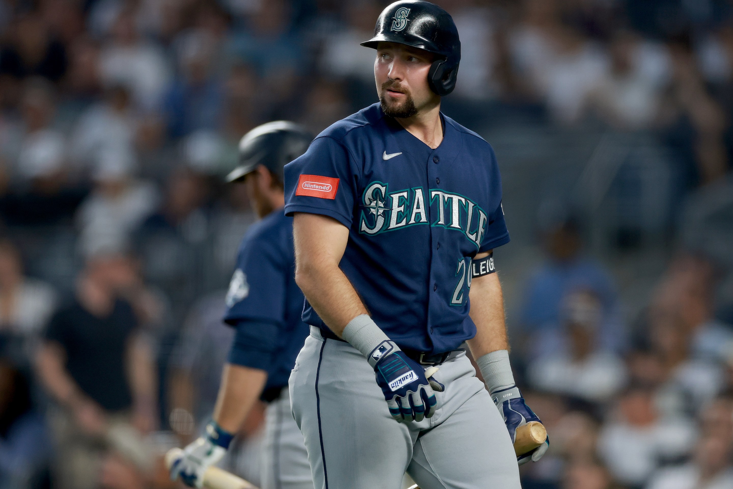 Cal Raleigh #29 of the Seattle Mariners heads back to the dugout after striking out in the second inning against the New York Yankees.
