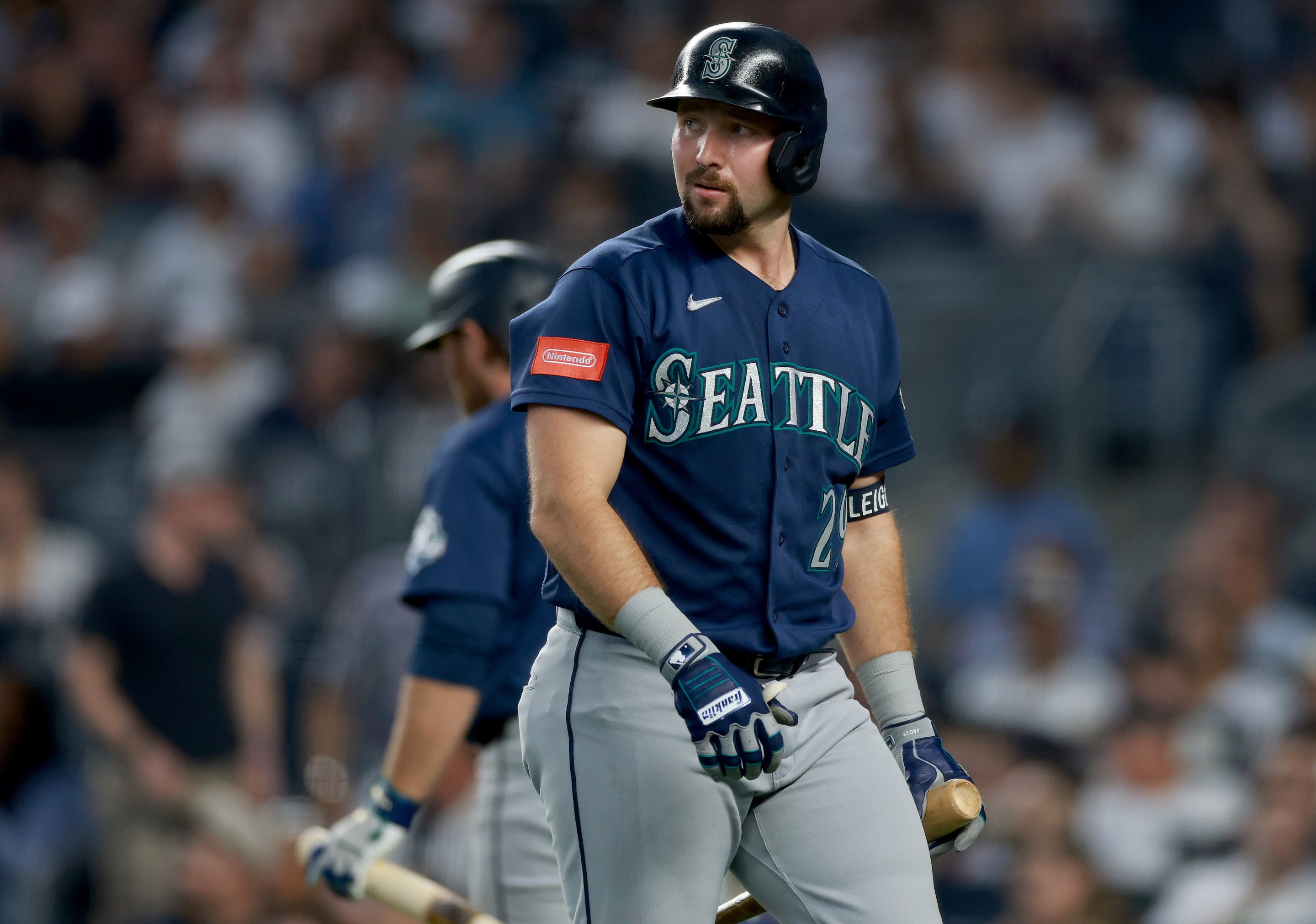 Cal Raleigh #29 of the Seattle Mariners heads back to the dugout after striking out in the second inning against the New York Yankees.