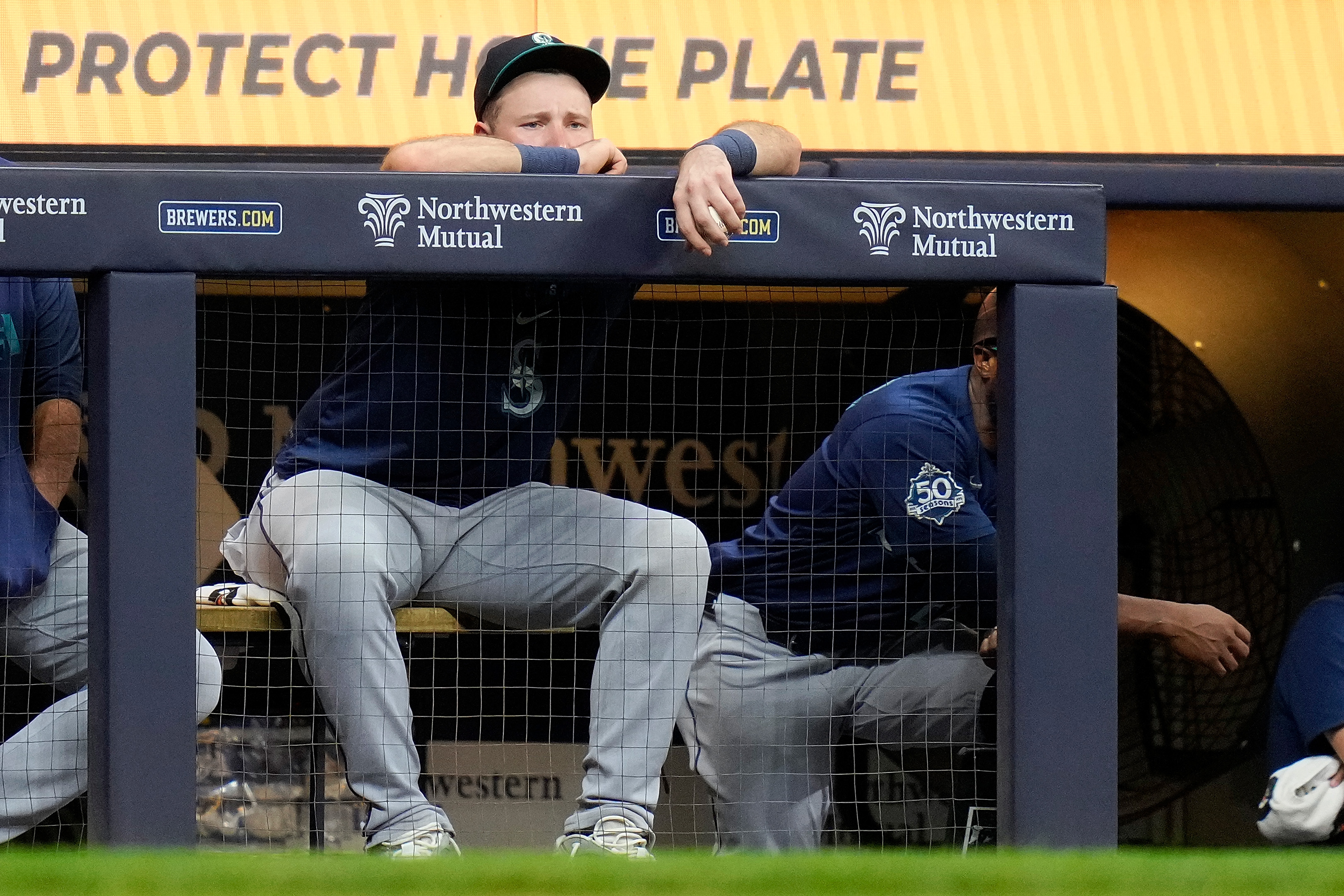 Cal Raleigh #29 of the Seattle Mariners looks on in the seventh inning after being taken out of game down 11-0 to the Milwaukee Brewers.