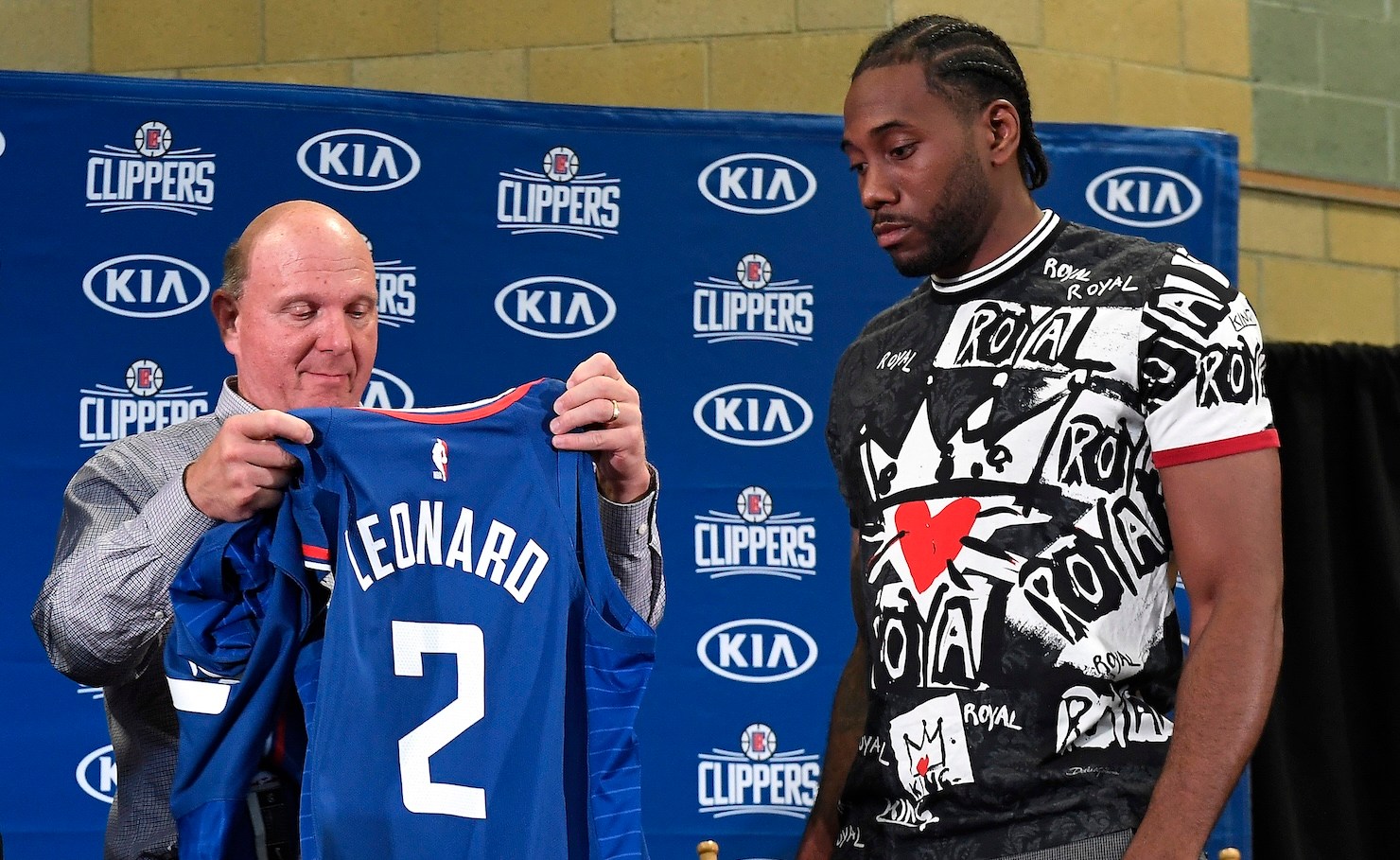 LOS ANGELES, CALIFORNIA - JULY 24: Los Angeles Clippers owner Steve Ballmer hands Kawhi Leonard his jersey as he and Paul George are introduced at Green Meadows Recreation Center on July 24, 2019 in Los Angeles, California. NOTE TO USER: User expressly acknowledges and agrees that, by downloading and or using this photograph, User is consenting to the terms and conditions of the Getty Images License Agreement. (Photo by Kevork Djansezian/Getty Images)