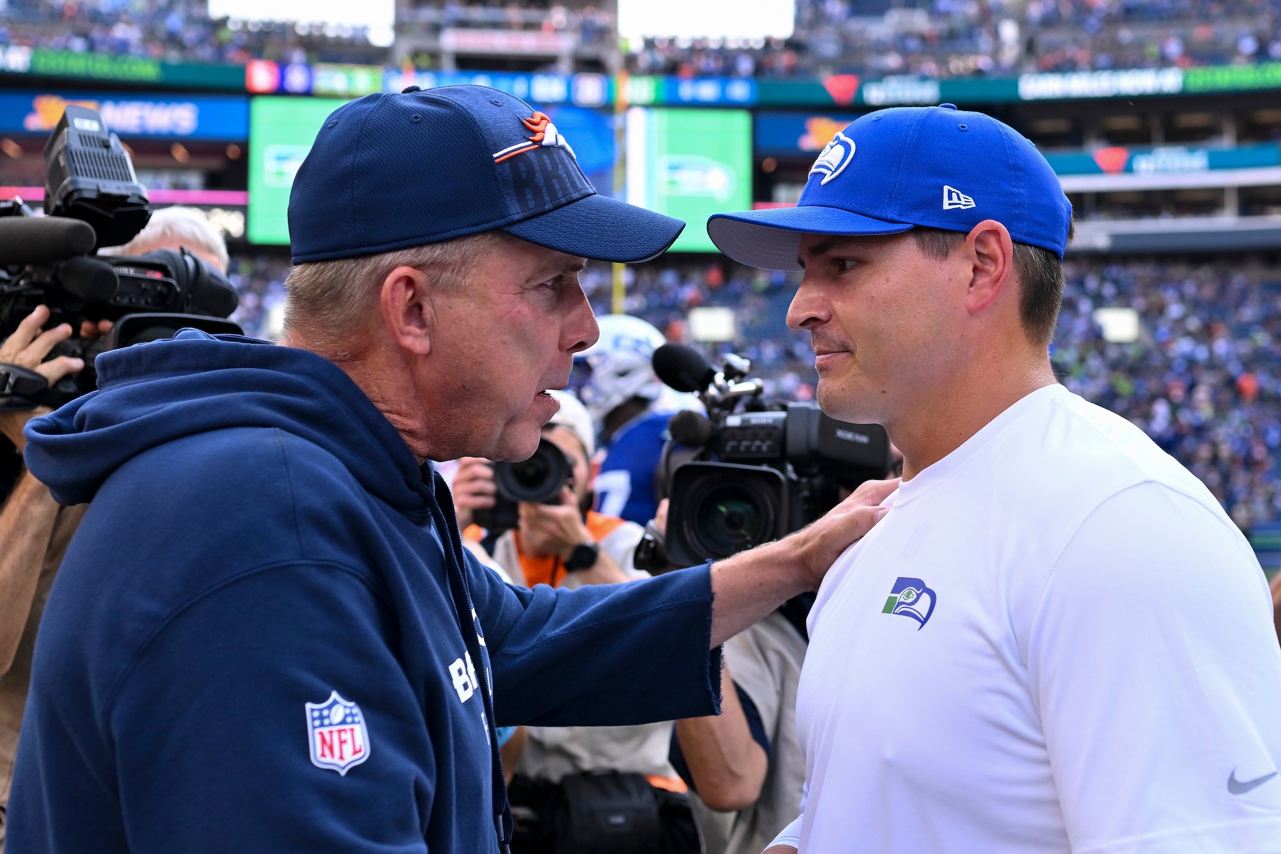 Sean Payton and Mike Macdonald talk on the field in 2024