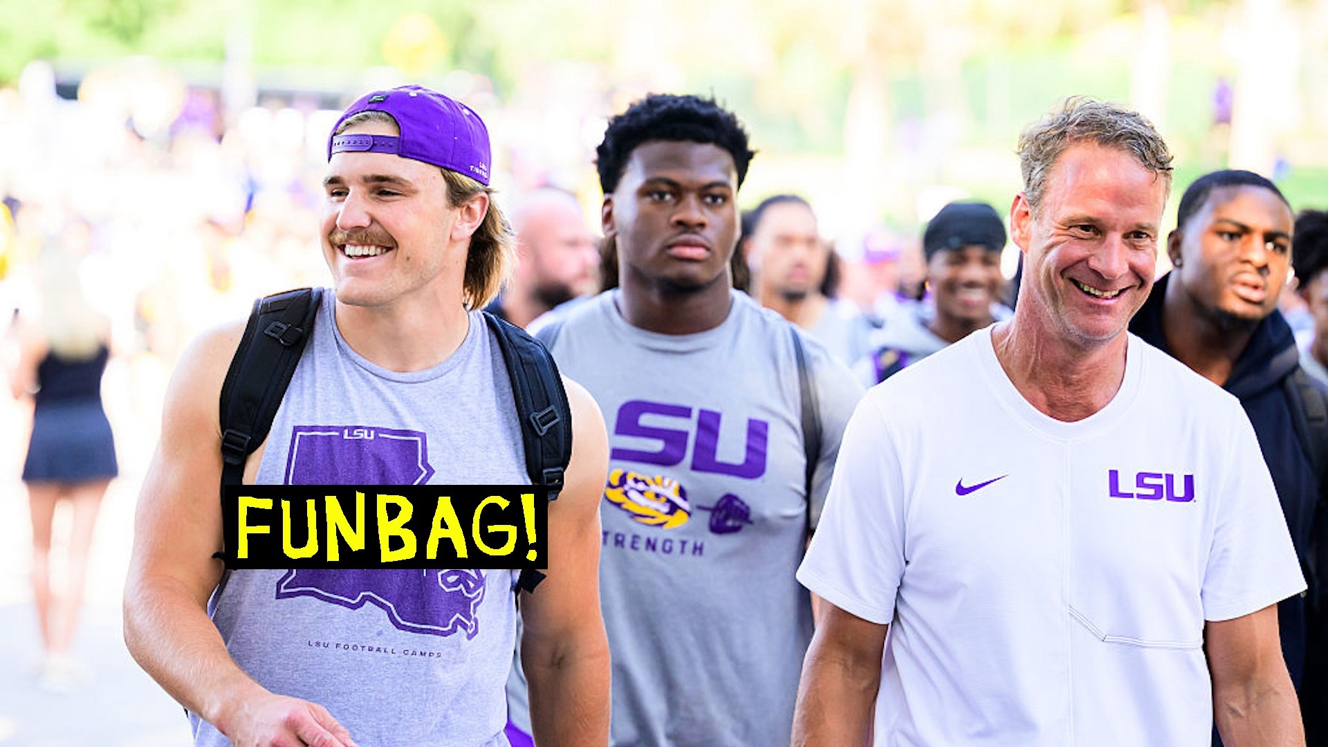 Whit Weeks #7 and head coach Lane Kiffin of the LSU Tigers walk down victory hill before fall practice at Tiger Stadium