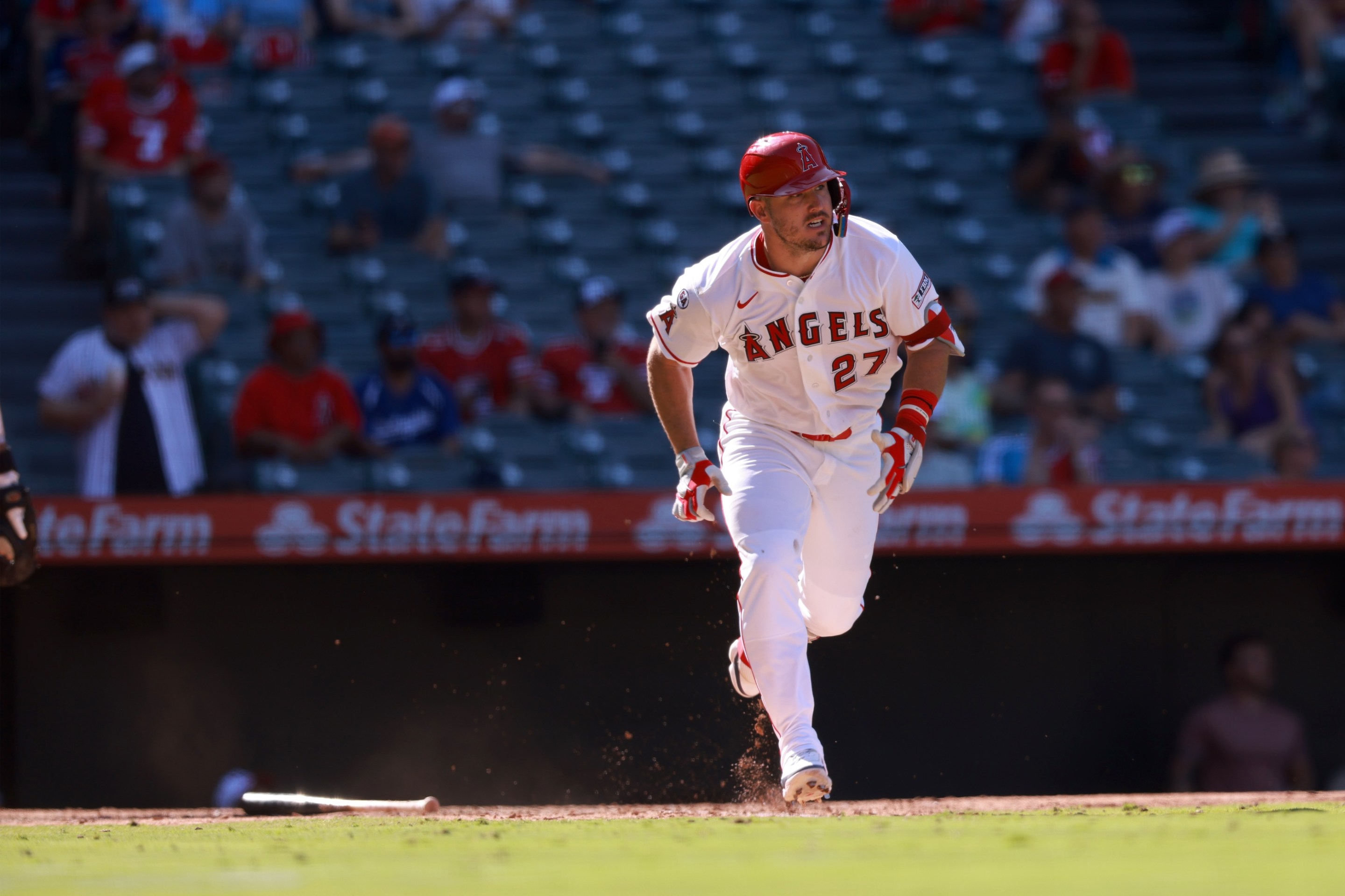 Mike Trout of the Los Angeles Angles hits a double in the ninth inning during the game against the Philadelphia Phillies at Angel Stadium. There's basically no one in the seats behind home plate.