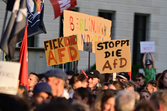 07 September 2026, Berlin: Participants hold signs during a demonstration at the Brandenburg Gate. Under the slogan "Time to Act: Stop the AfD!" Campact and Fridays for Future had called for the rally at the Brandenburg Gate. Among the announced speakers were Eralp, the leading candidate for Berlin's Left Party, and Pantisano, the federal chair of the Left Party. Photo: Fabian Sommer/dpa (Photo by Fabian Sommer/picture alliance via Getty Images)