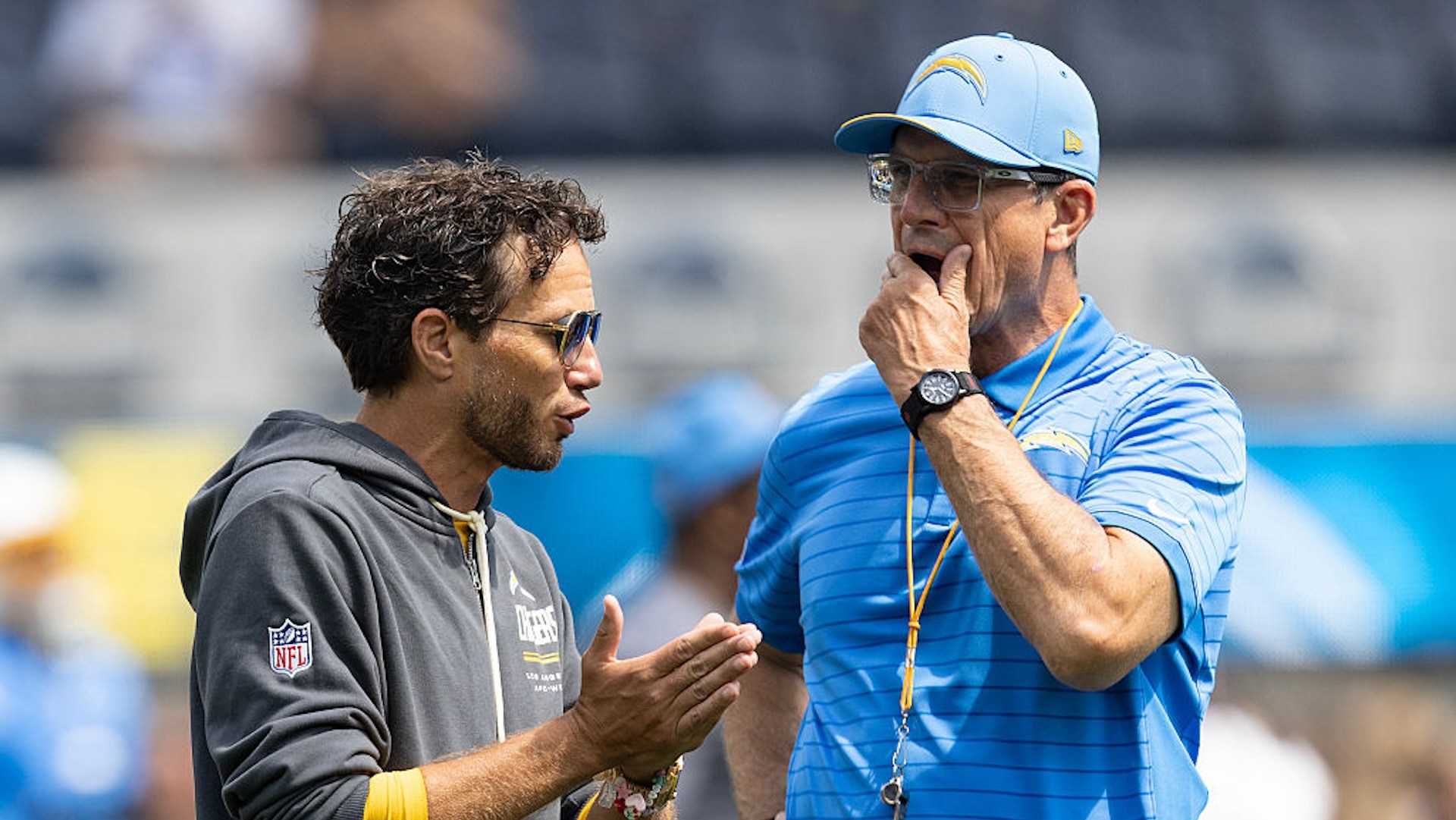 Mike McDaniel talks with Jim Harbaugh