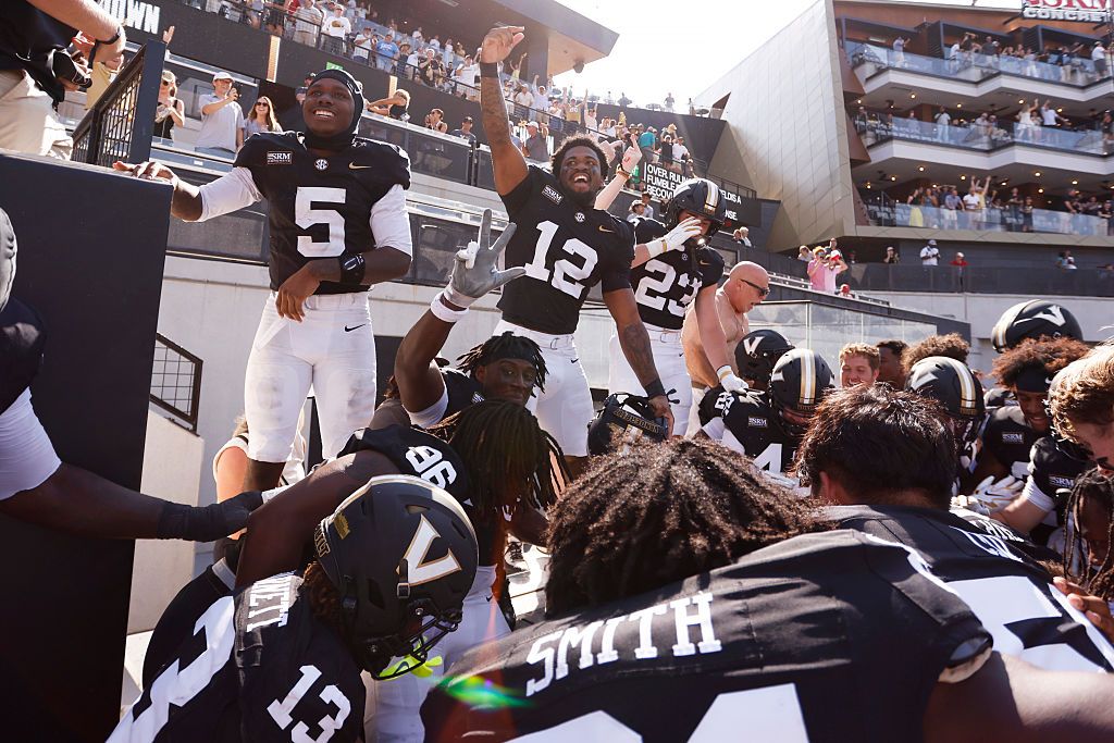 Members of the Vanderbilt Commodores football team react after a last second fumble return in the endzone won the game against NC State, 35-31