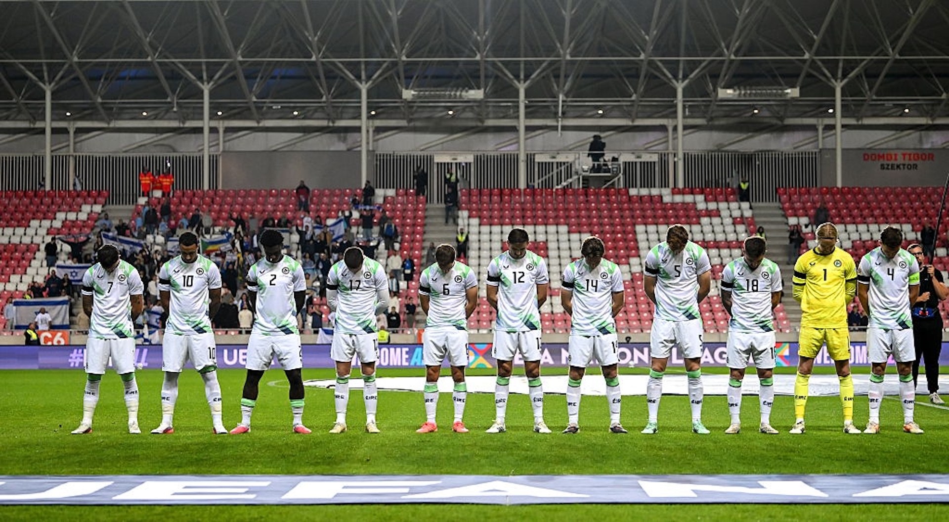 Irish players bow their heads during the Israeli anthem