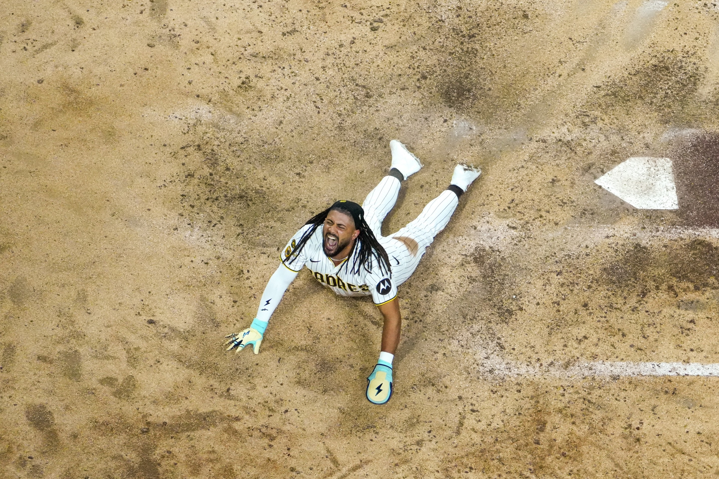 Fernando Tatis Jr. celebrates at home plate after scoring in the seventh inning during Game One of the National League Wild Card Series presented by AbbVie between the Chicago Cubs and the San Diego Padres at Petco Park on Tuesday, September 29, 2026.