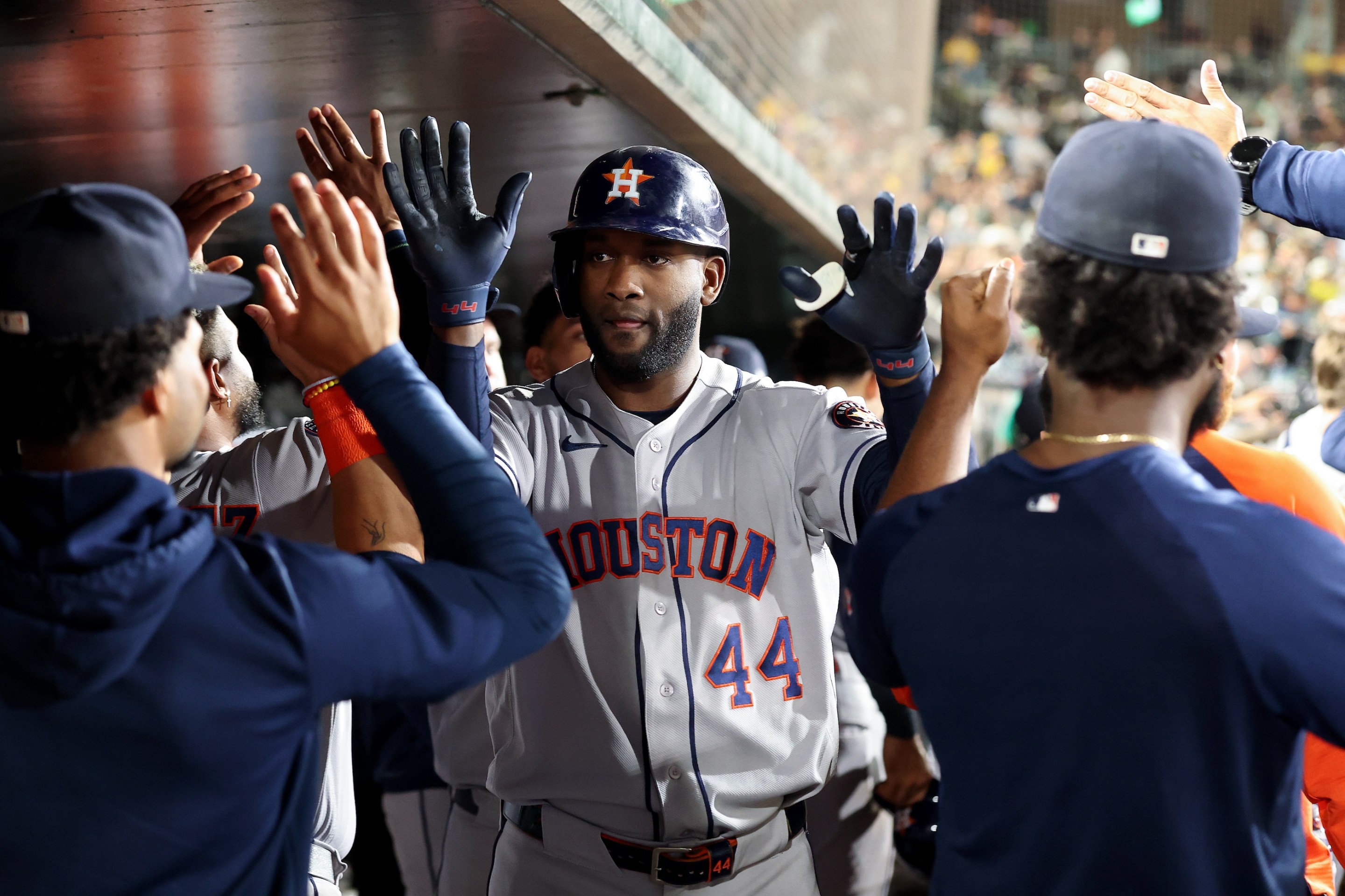 Yordan Alvarez #44 of the Houston Astros is congratulated by teammates in the dugout after he hit a three-run home run against the Athletics during the fifth inning on September 26, 2026.