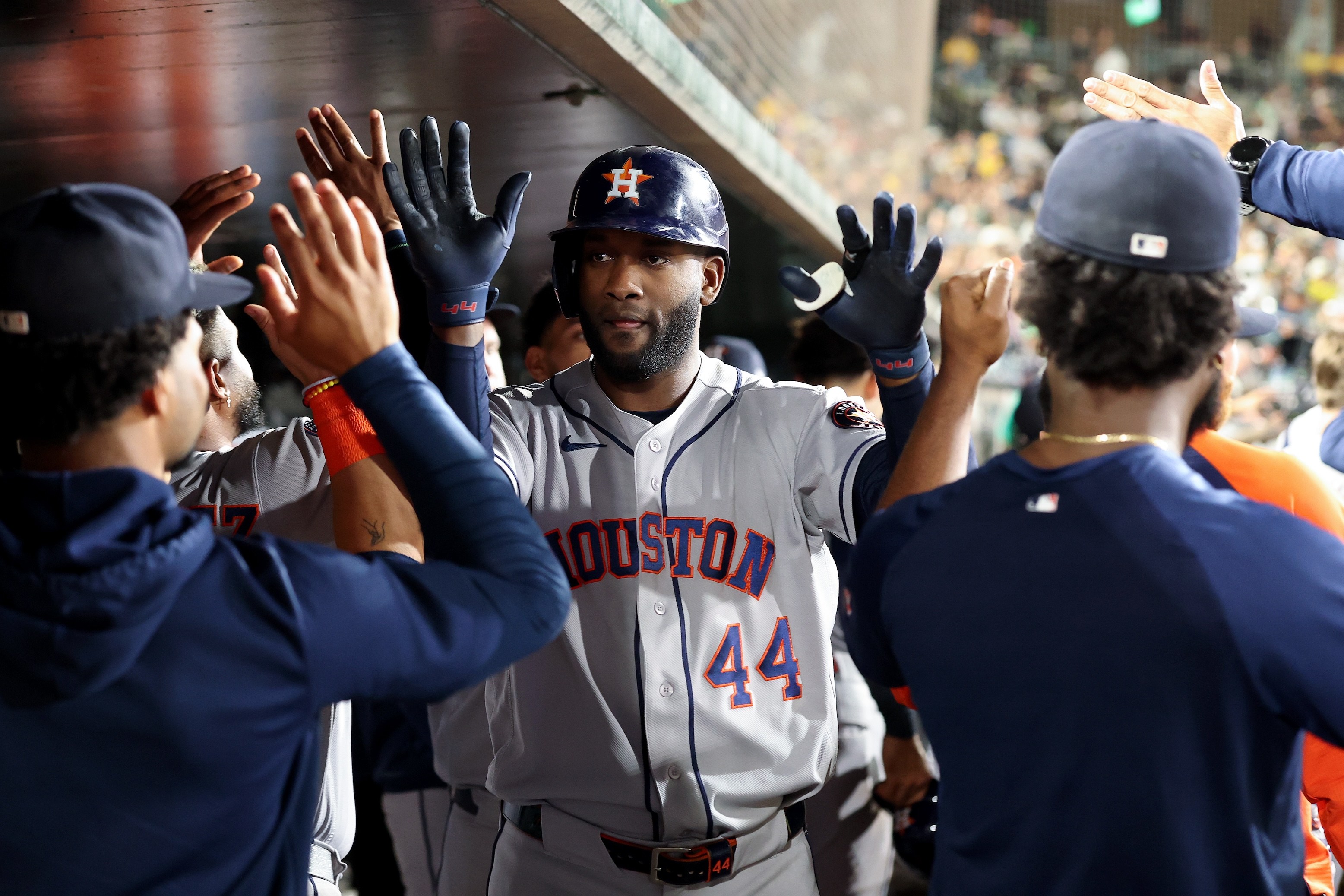 Yordan Alvarez #44 of the Houston Astros is congratulated by teammates in the dugout after he hit a three-run home run against the Athletics during the fifth inning on September 26, 2026.