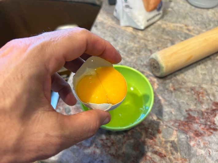 Half of an egg shell, holding two egg yolks.