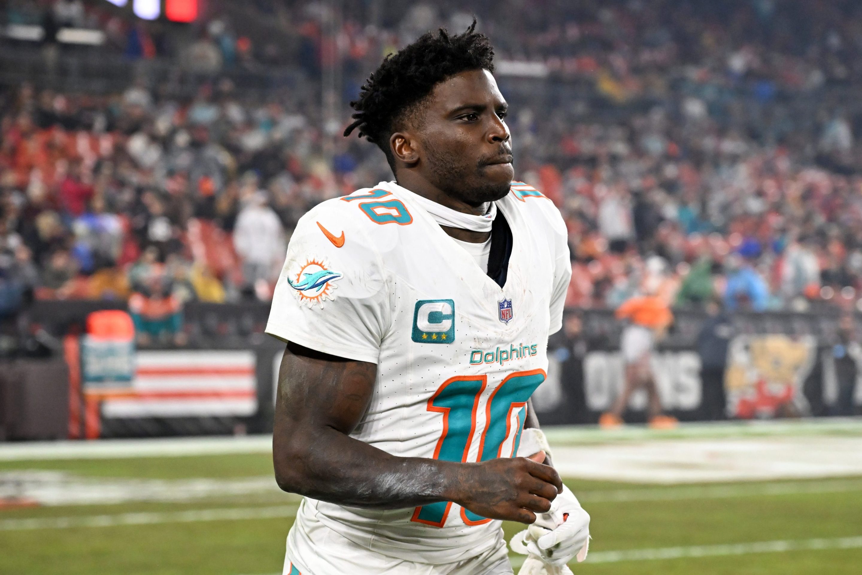 Tyreek Hill #10 of the Miami Dolphins runs onto the field at halftime against the Cleveland Browns at Huntington Bank Field on December 29, 2024 in Cleveland, Ohio.