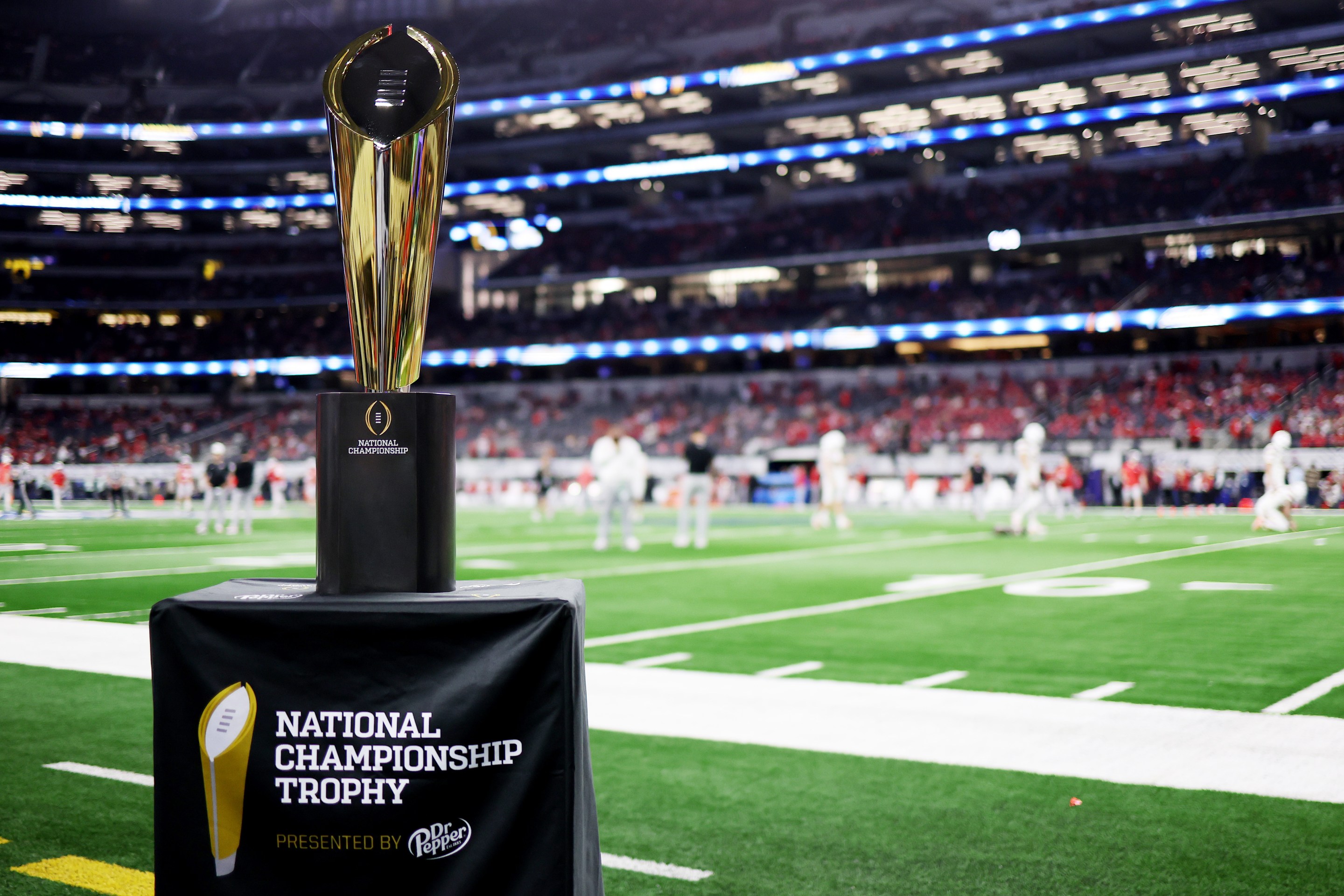 ARLINGTON, TEXAS - DECEMBER 31: A detailed view of the National Championship trophy prior to a game between the Miami Hurricanes and the Ohio State Buckeyes during the 2025 College Football Playoff Quarterfinal at the 90th Goodyear Cotton Bowl Classic at AT&T Stadium on December 31, 2025 in Arlington, Texas.