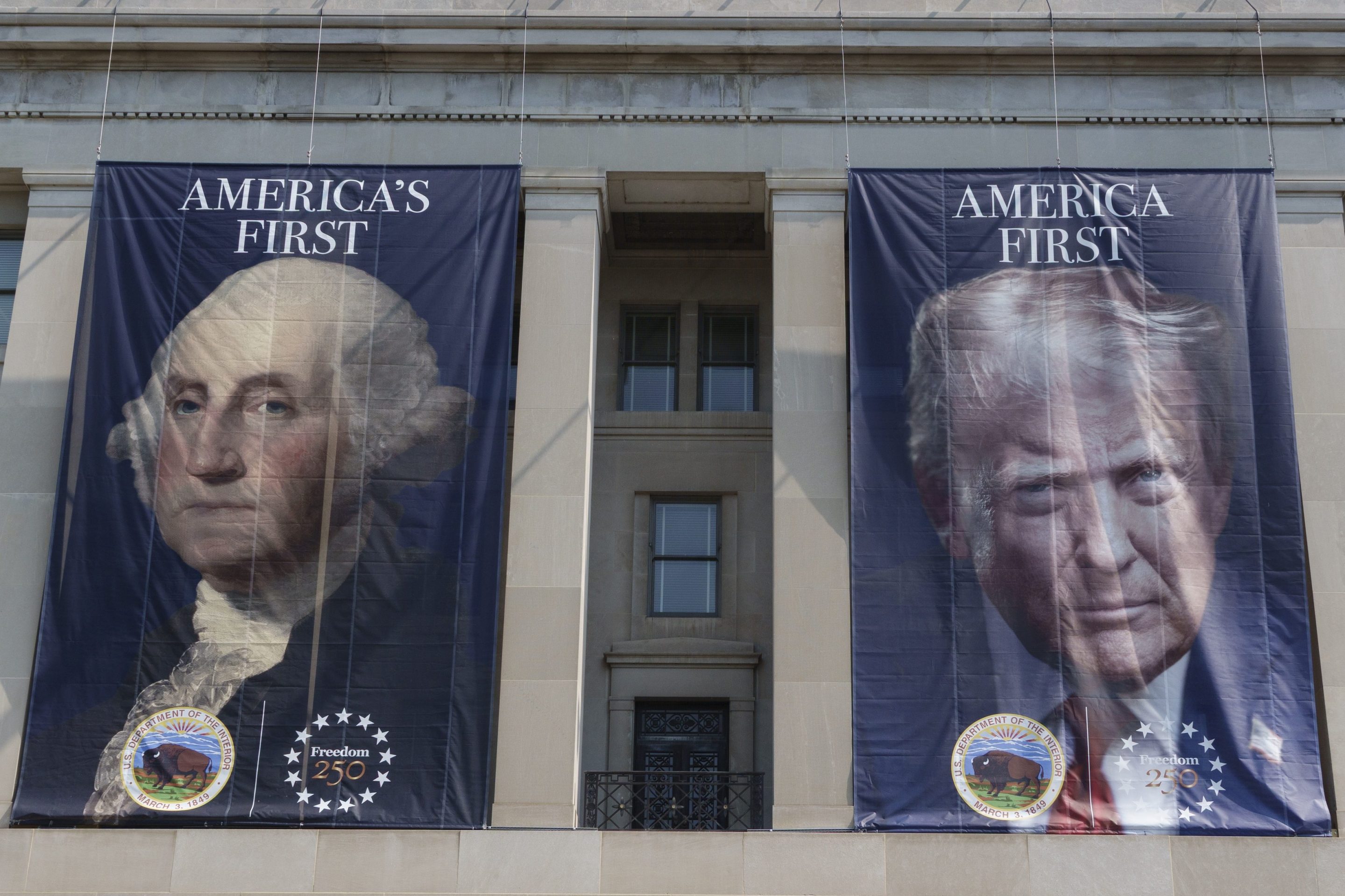 WASHINGTON, DC - JULY 15: Banners with portraits of U.S. President George Washington and Donald Trump are displayed on the Stewart Lee Udall Department of the Interior building on July 15, 2026 in Washington, DC. (Photo by Kevin Carter/Getty Images)