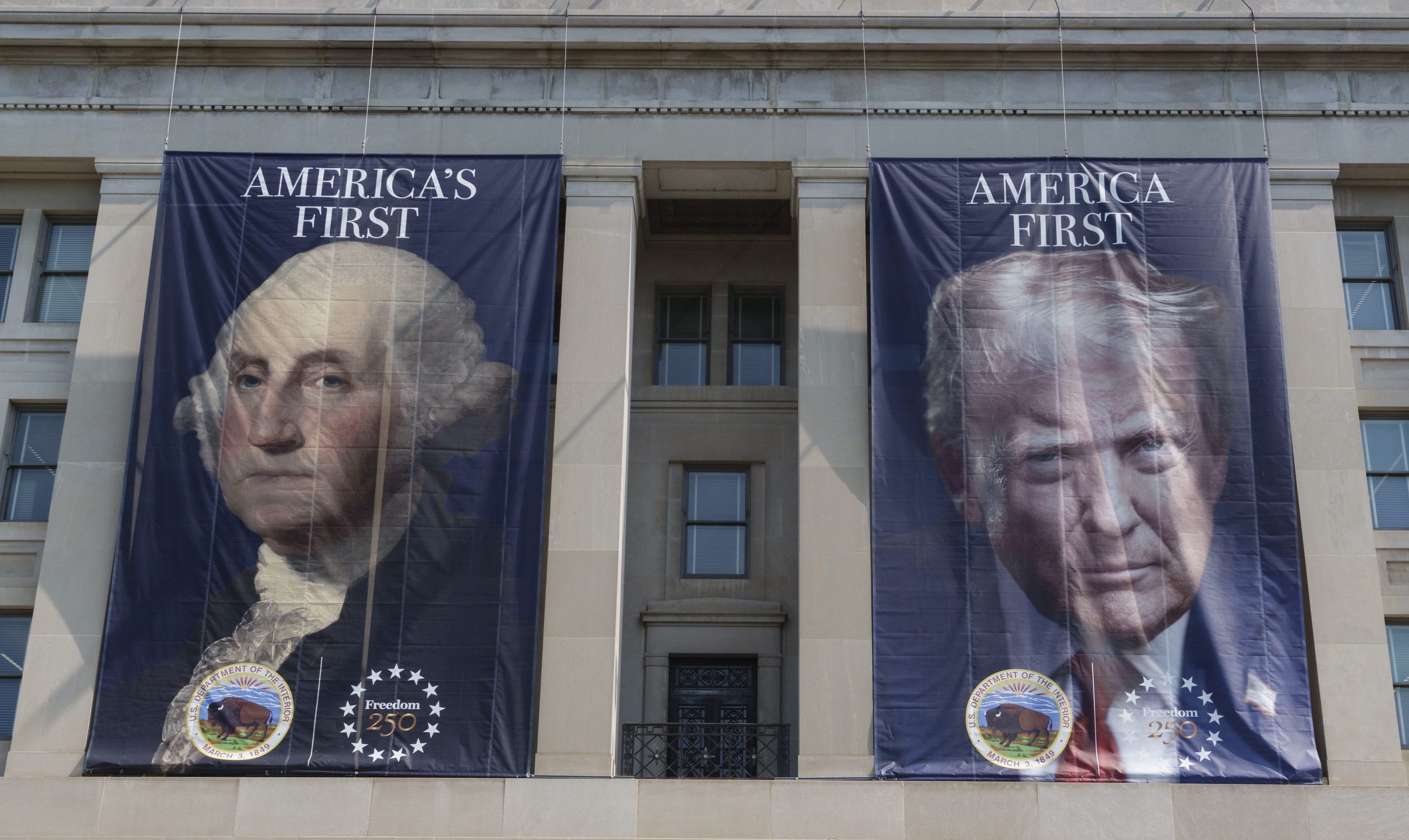 WASHINGTON, DC - JULY 15: Banners with portraits of U.S. President George Washington and Donald Trump are displayed on the Stewart Lee Udall Department of the Interior building on July 15, 2026 in Washington, DC. (Photo by Kevin Carter/Getty Images)
