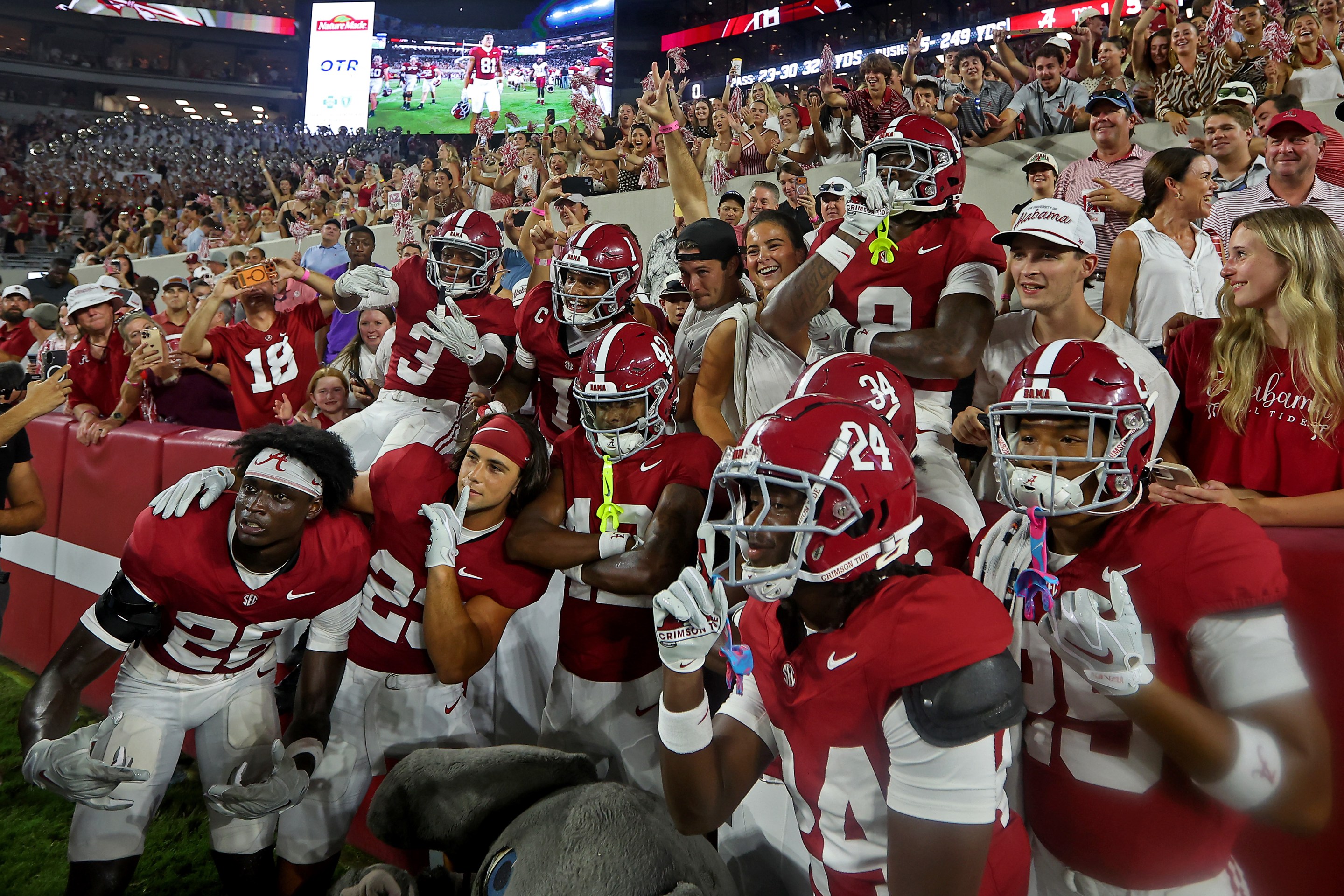 TUSCALOOSA, ALABAMA - SEPTEMBER 19: Alabama Crimson Tide players pose with fans after beating the Florida State Seminoles 50-36 at Bryant-Denny Stadium on September 19, 2026 in Tuscaloosa, Alabama.