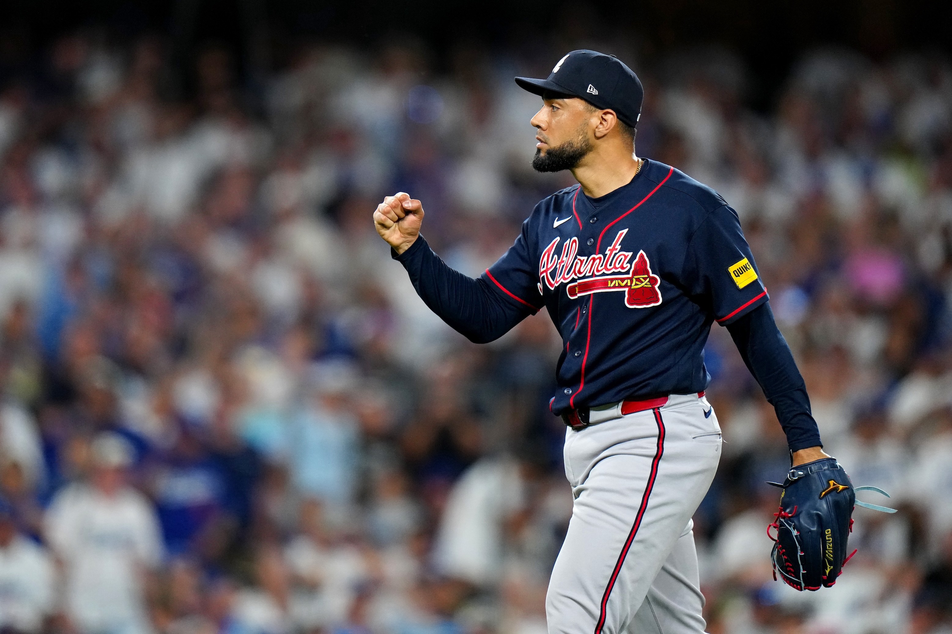 Didier Fuentes of the Atlanta Braves reacts to a play during Game Two of the National League Division Series. Positively, at that. He's in profile, pumping his fist.