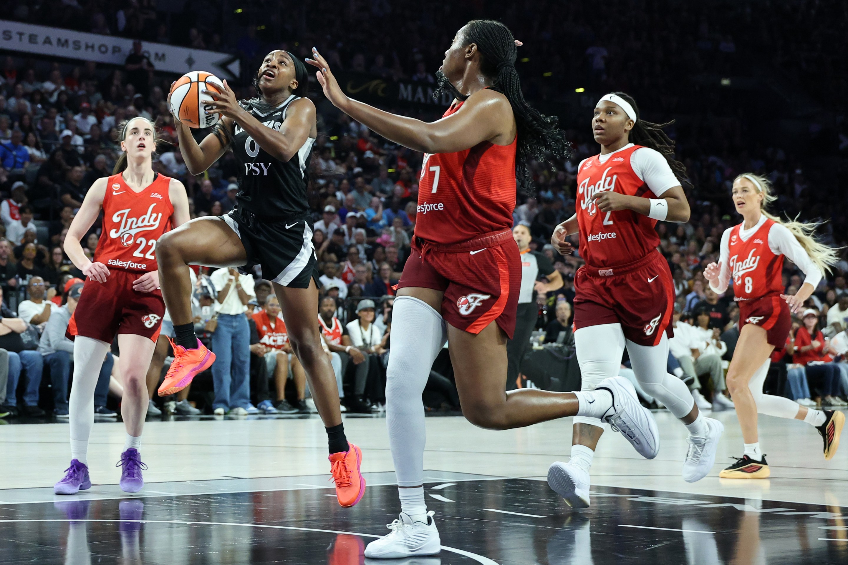 Jackie Young #0 of the Las Vegas Aces drives to the basket against Aliyah Boston #7 of the Indiana Fever in the second quarter of Game Three of the 2026 WNBA Playoffs