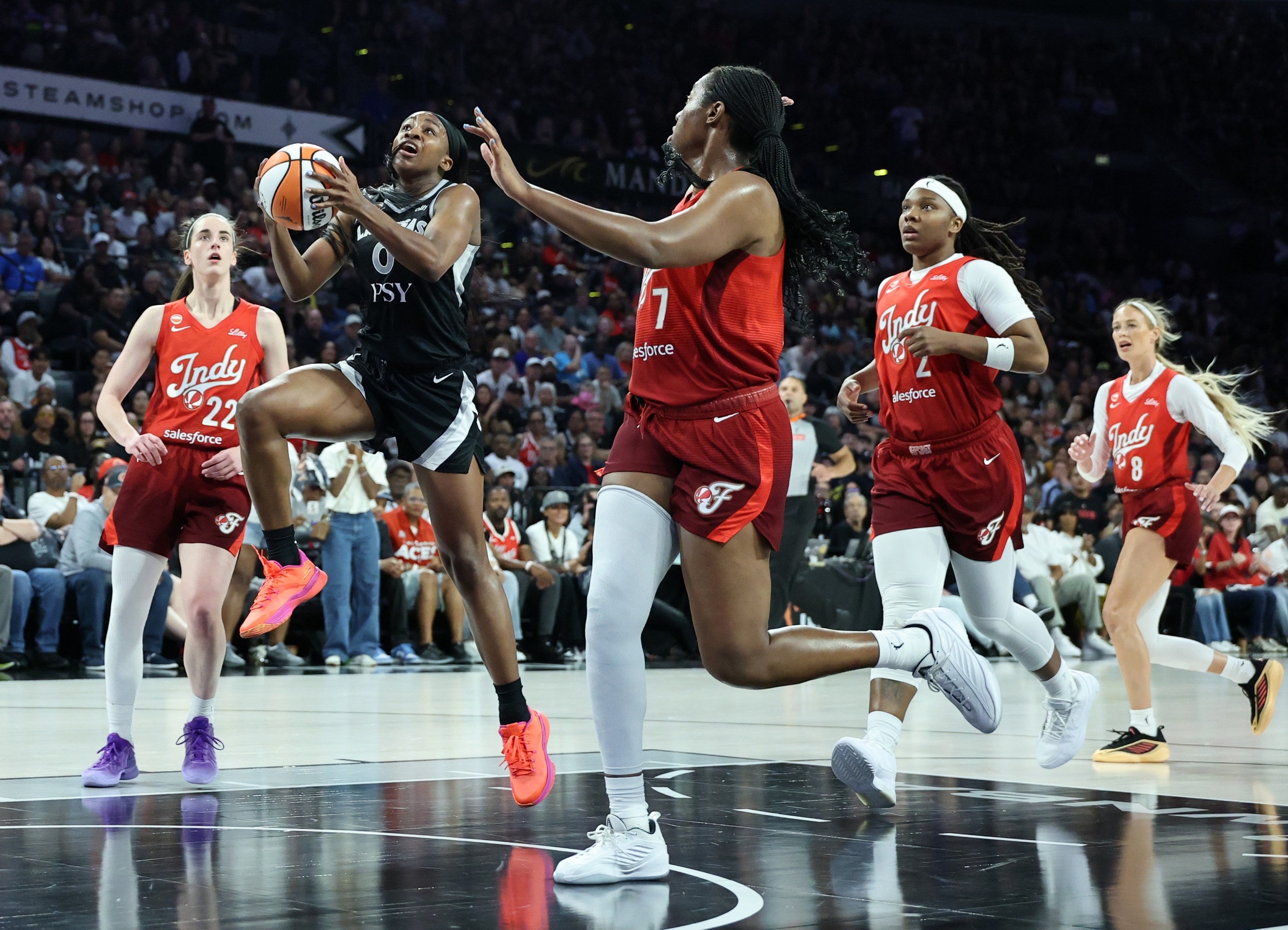 Jackie Young #0 of the Las Vegas Aces drives to the basket against Aliyah Boston #7 of the Indiana Fever in the second quarter of Game Three of the 2026 WNBA Playoffs