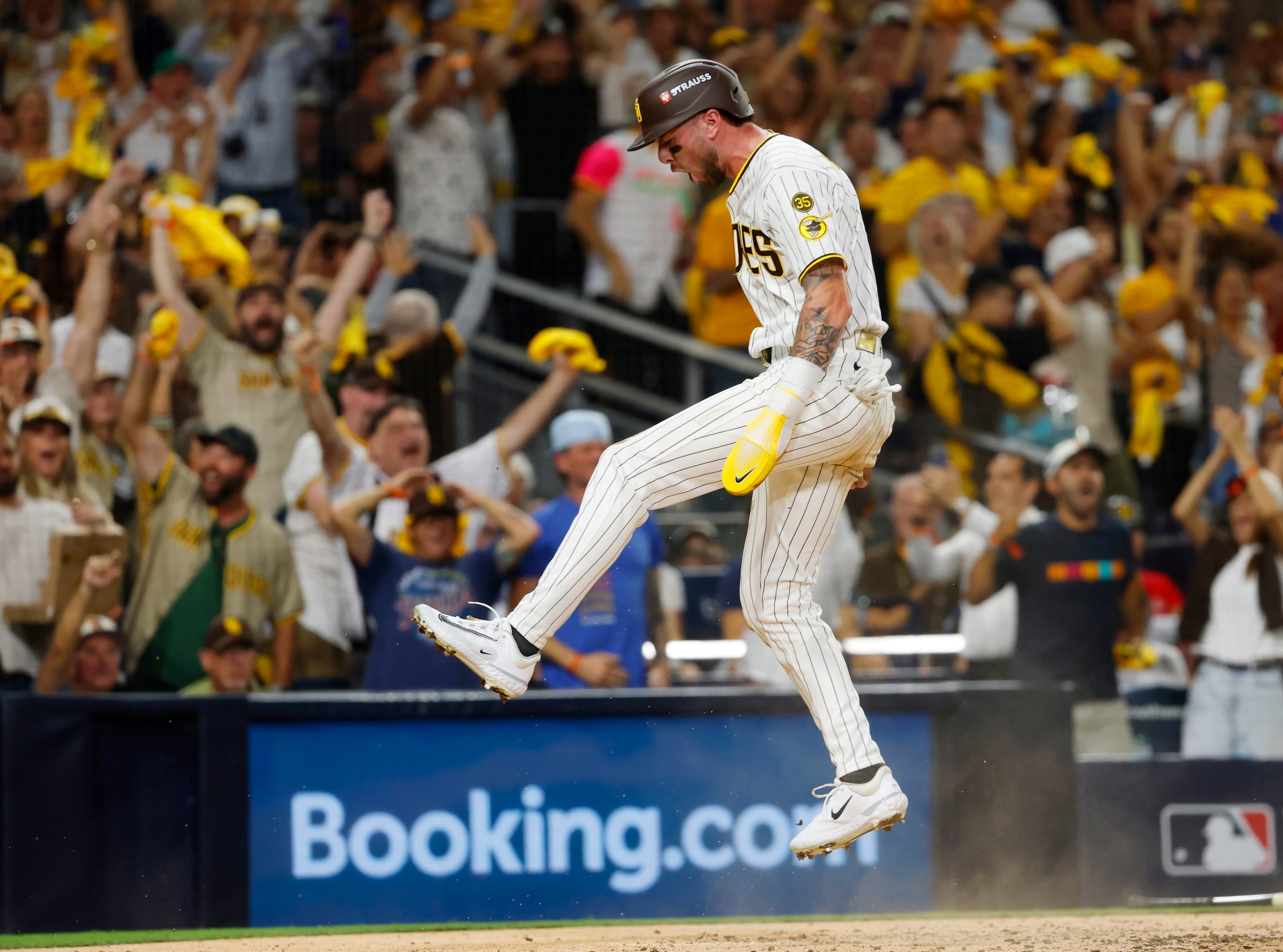 Jackson Merrill #3 of the San Diego Padres celebrates after scoring in the third inning against the Milwaukee Brewers during game three of the National League Division Series in San Diego on October 6, 2026.