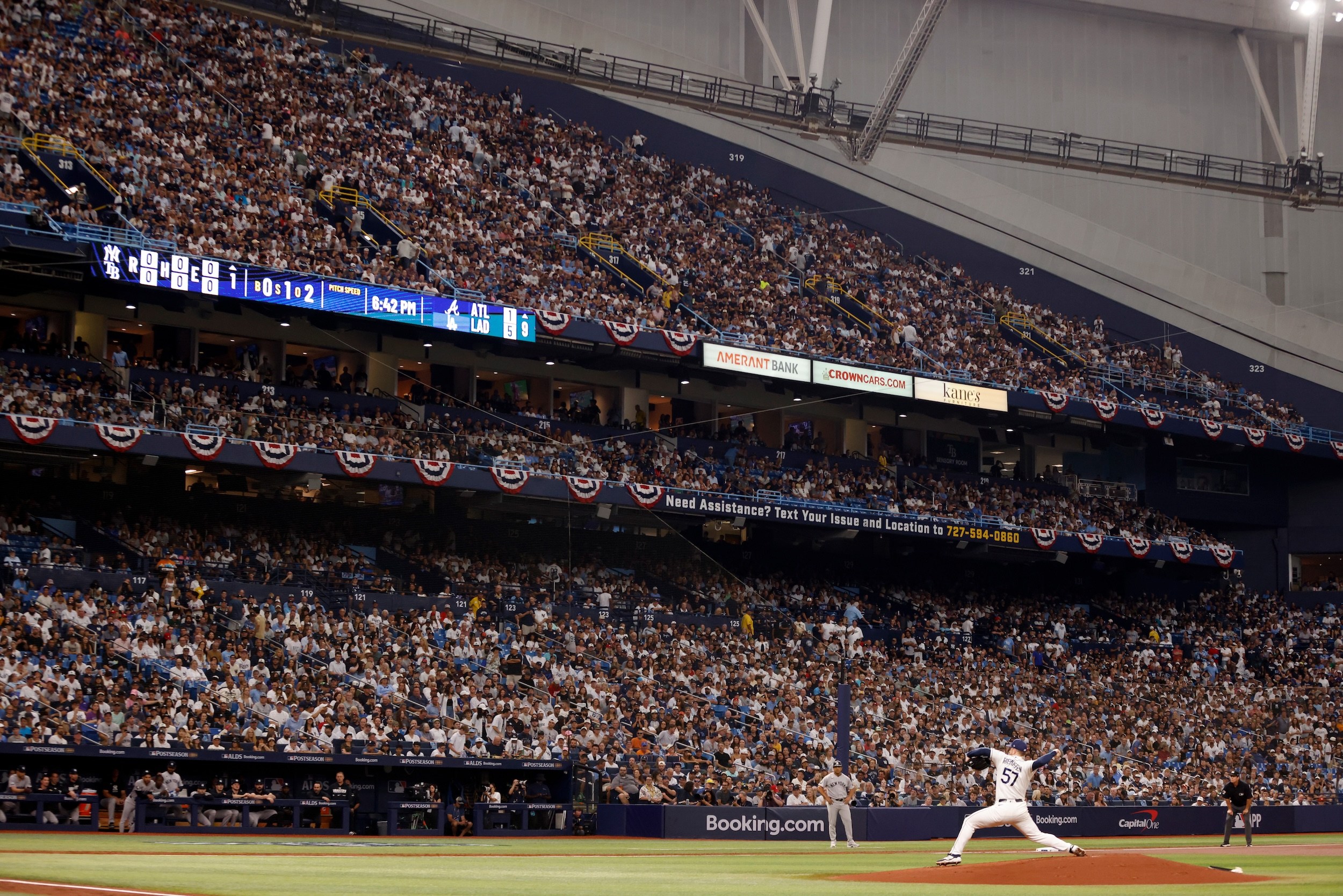 Drew Rasmussen throws a pitch in front of packed stands.