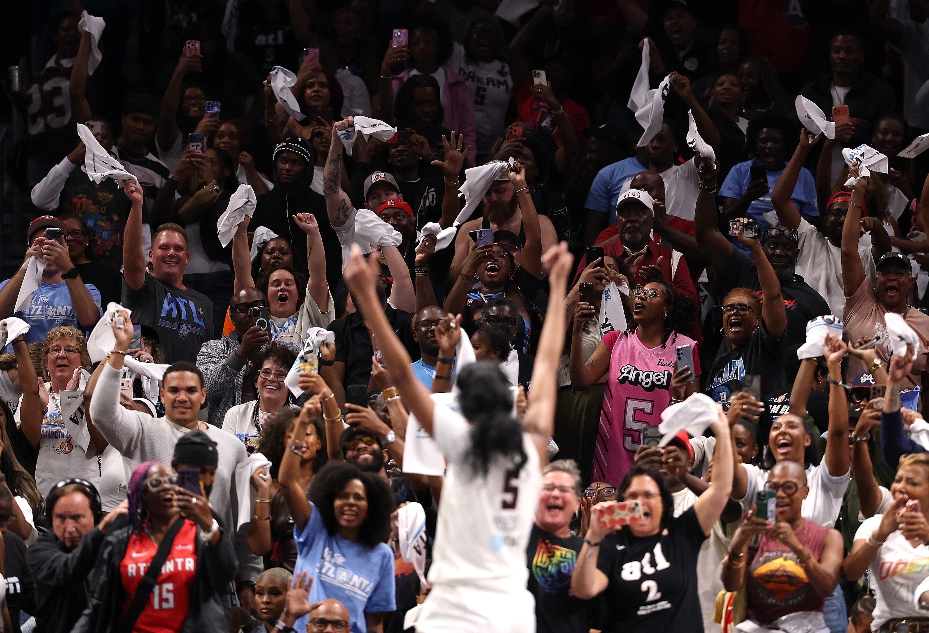 Fans react to Angel Reese #5 of the Atlanta Dream celebrating in the final seconds of their 92-82 win over the New York Liberty in game one of the semifinals of the WNBA playoffs at State Farm Arena on October 04, 2026 in Atlanta, Georgia.