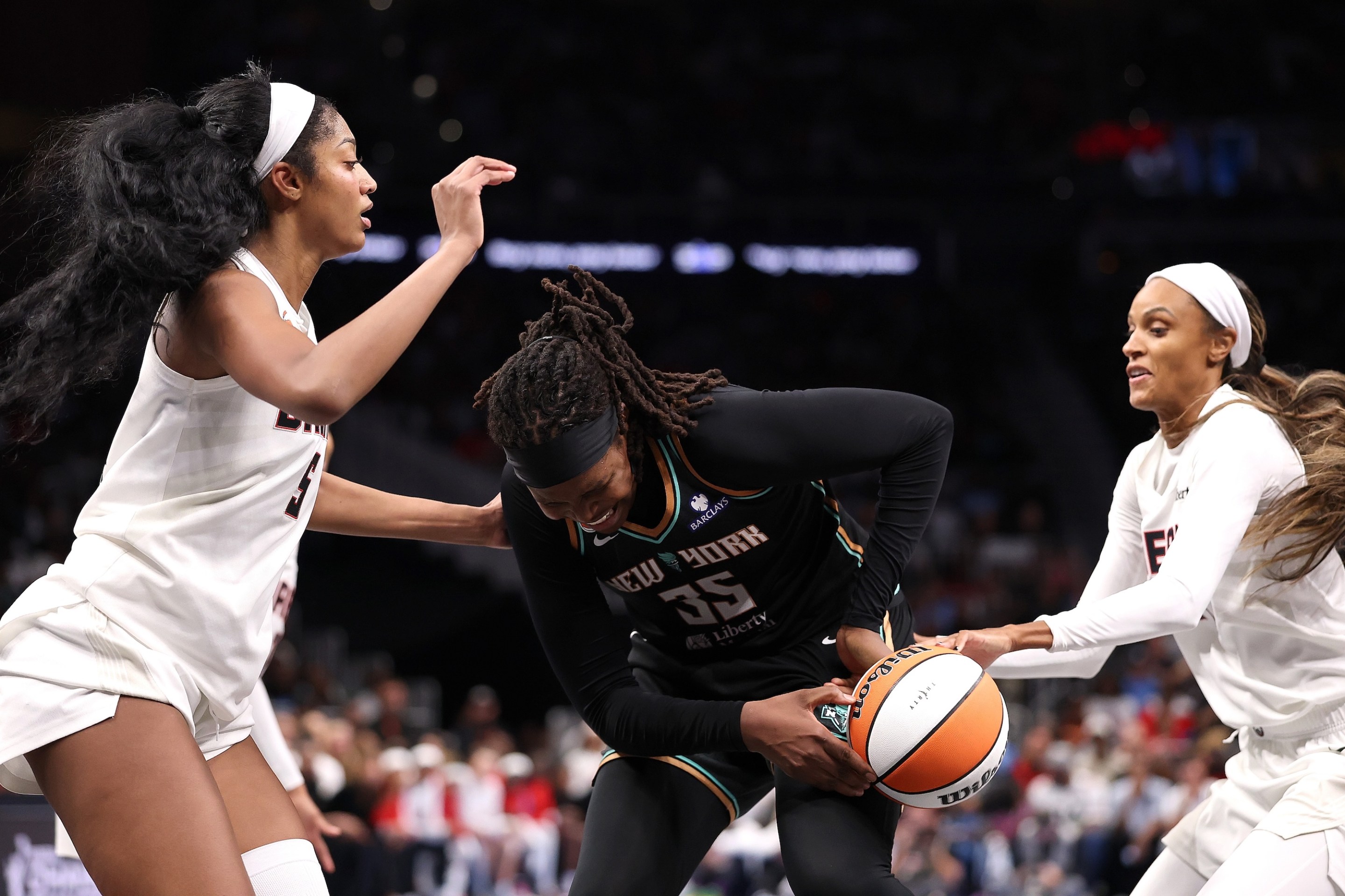 Angel Reese #5 defends as DeWanna Bonner #24 of the Atlanta Dream steals the ball from Jonquel Jones #35 of the New York Liberty during the fourth quarter of game one of the semifinals of the WNBA playoffs at State Farm Arena on October 04, 2026 in Atlanta, Georgia.