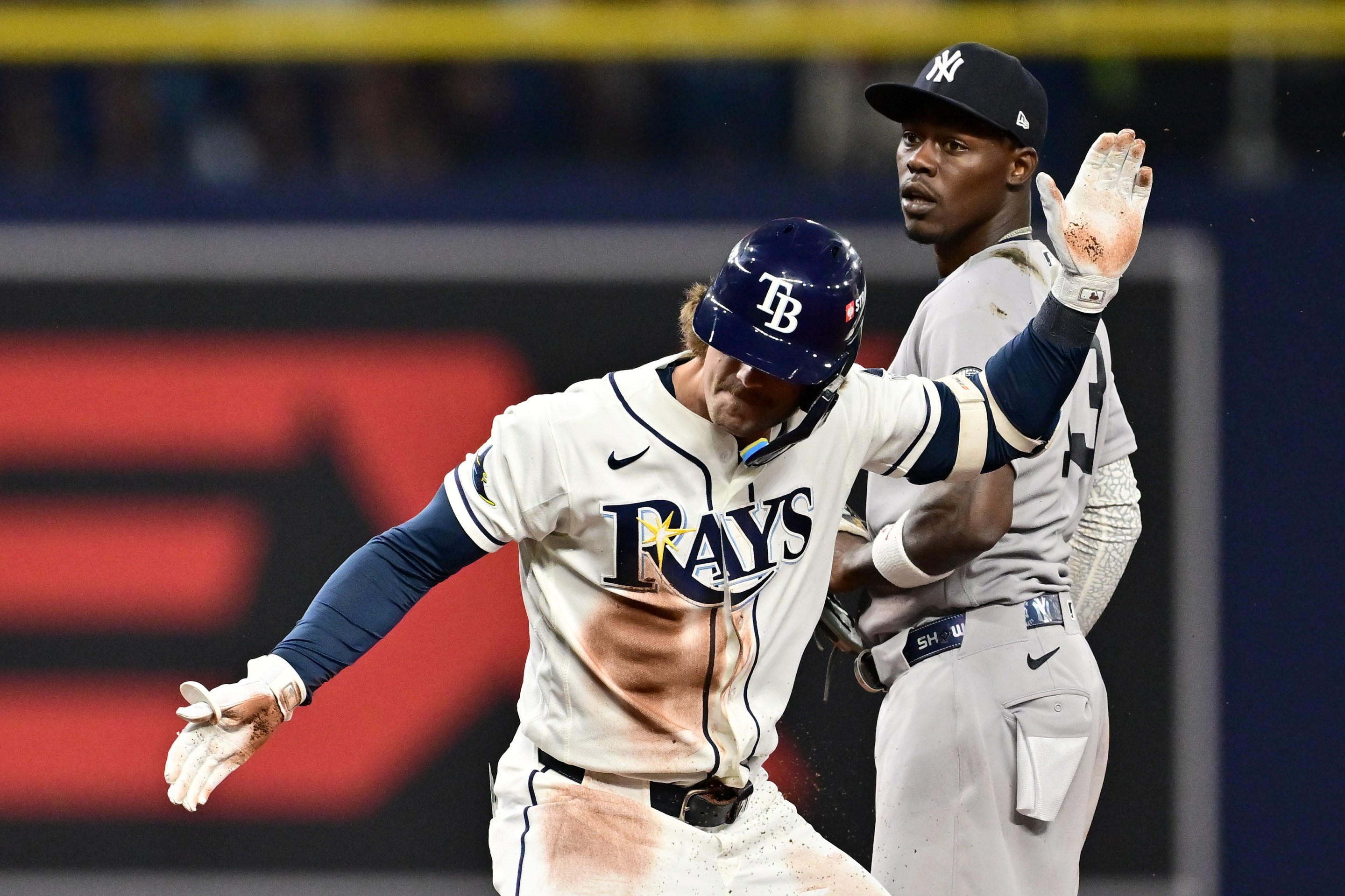 Jonny DeLuca of the Tampa Bay Rays celebrates a double as Jazz Chisholm Jr. #13 of the New York Yankees looks on during the second inning in game two of the American League Division Series.