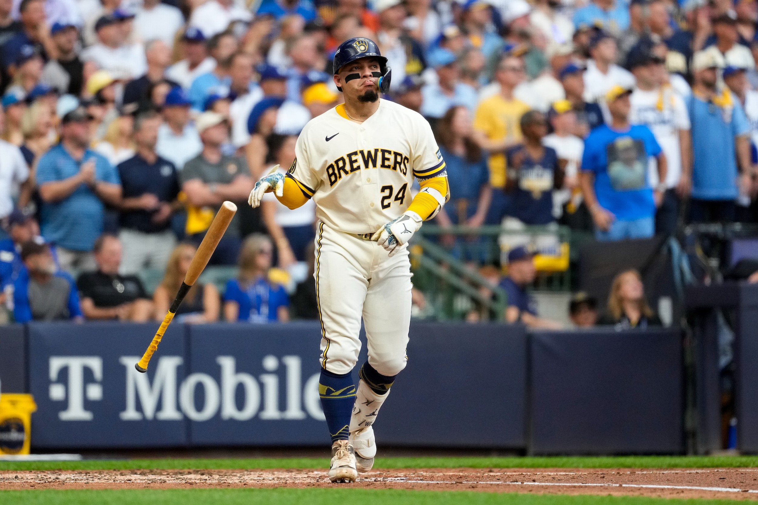William Contreras tosses his bat after drawing a walk.