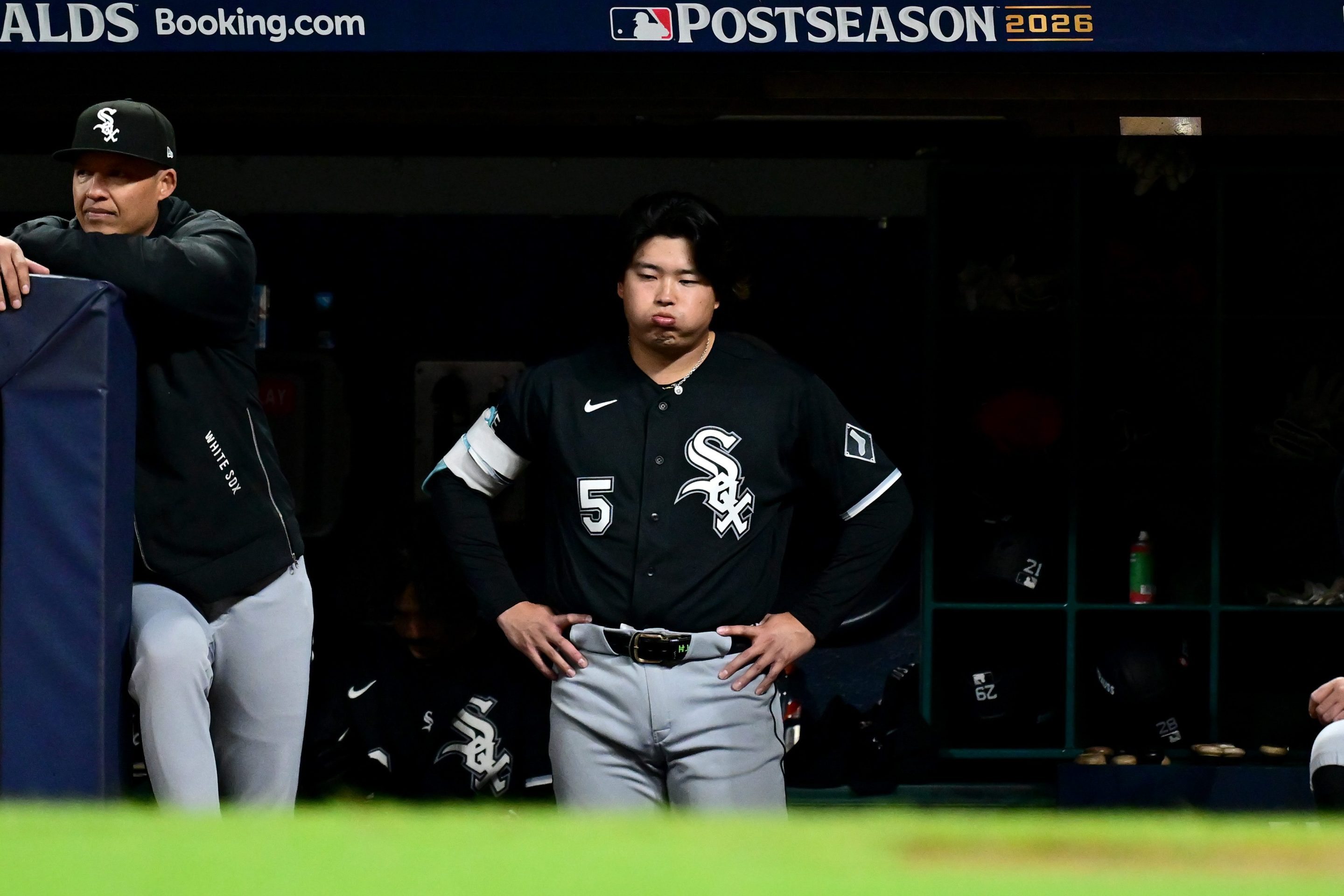 Munetaka Murakami #5 of the Chicago White Sox looks on from the dugout during the seventh inning in game five of the American League Division Series against the Cleveland Guardians at Progressive Field on October 10, 2026 in Cleveland, Ohio. He looks frustrated.