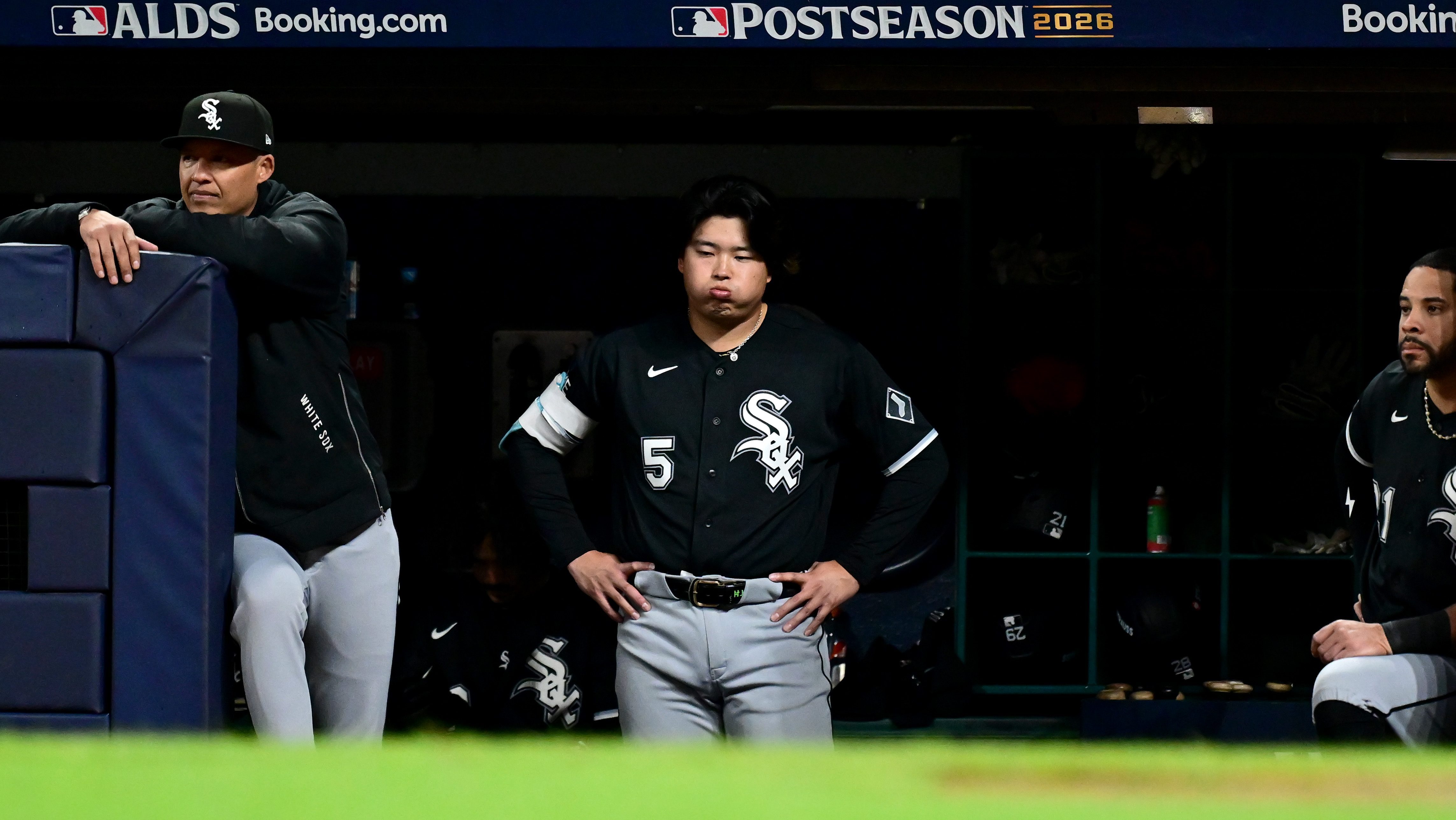 Munetaka Murakami #5 of the Chicago White Sox looks on from the dugout during the seventh inning in game five of the American League Division Series against the Cleveland Guardians at Progressive Field on October 10, 2026 in Cleveland, Ohio. He looks frustrated.