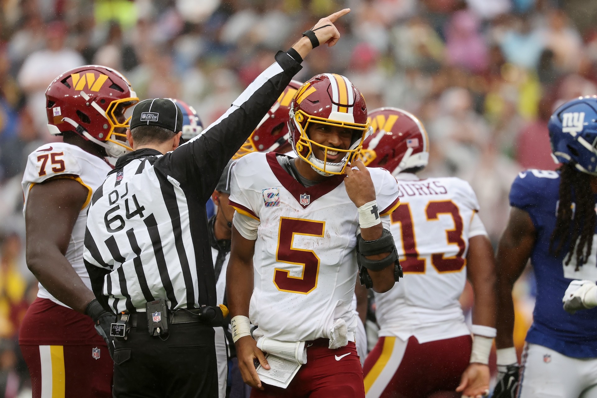 LANDOVER, MARYLAND - OCTOBER 11: Jayden Daniels #5 of the Washington Commanders reacts during the second quarter of the game against the New York Giants at Northwest Stadium on October 11, 2026 in Landover, Maryland.