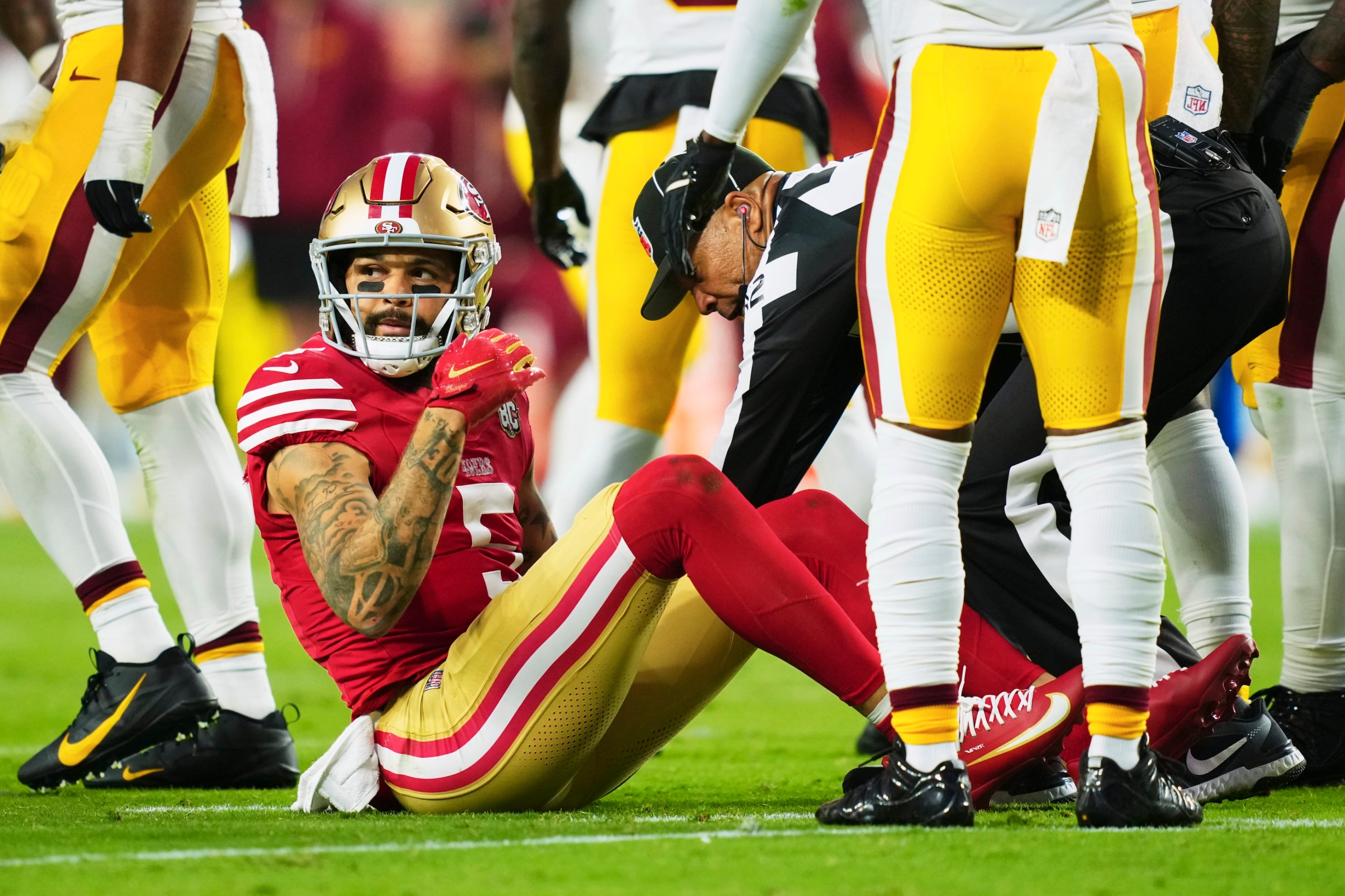 Mike Evans of the San Francisco 49ers sits on the ground after an injury against the Washington Commanders during the first half of an NFL football game at Levi's Stadium on October 19, 2026.