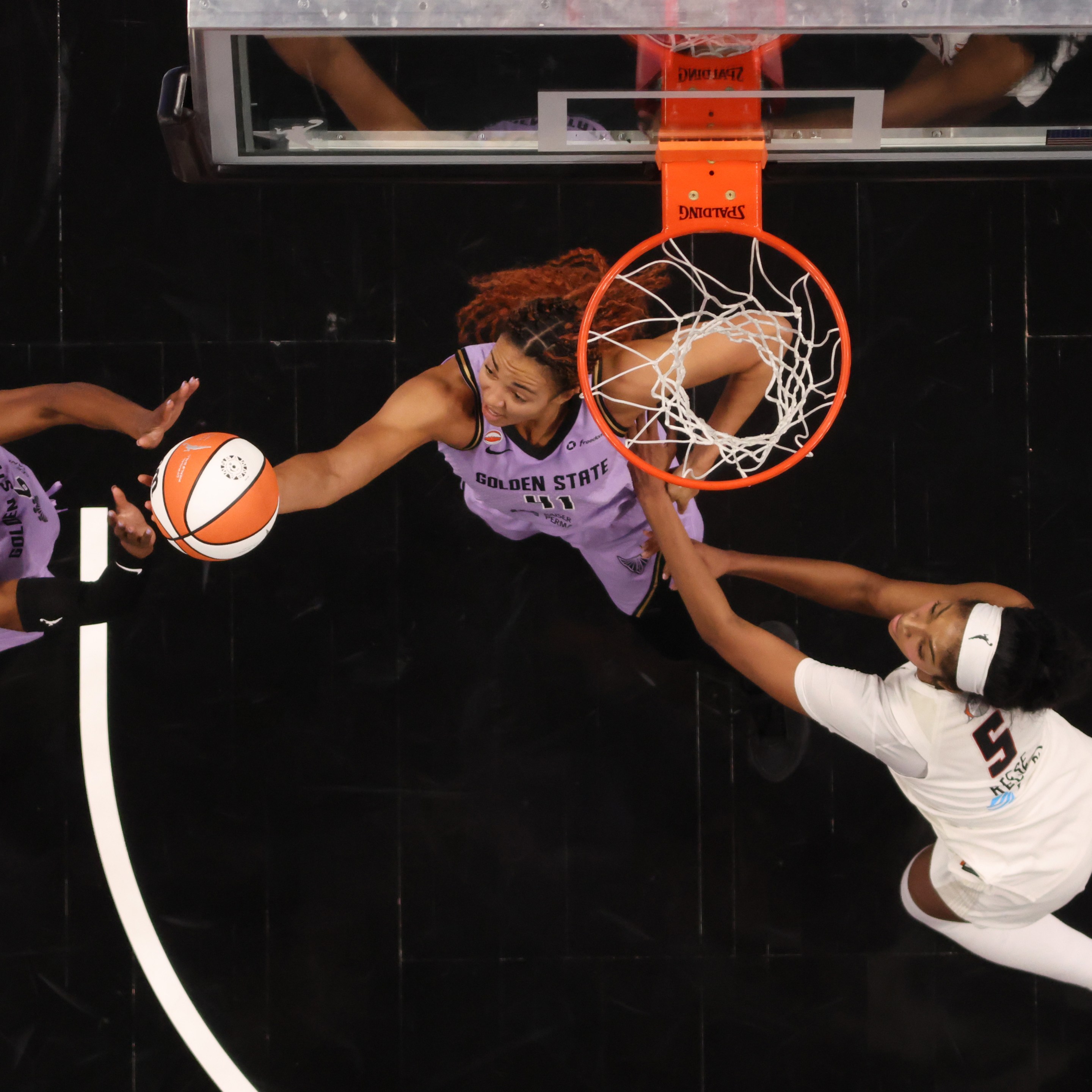Kaila Charles #6 and Kiah Stokes #41 of the Golden State Valkyries reach for a rebound against Angel Reese #5 of the Atlanta Dream during the third quarter in game four of the 2026 WNBA Finals at State Farm Arena on October 24, 2026 in Atlanta, Georgia.