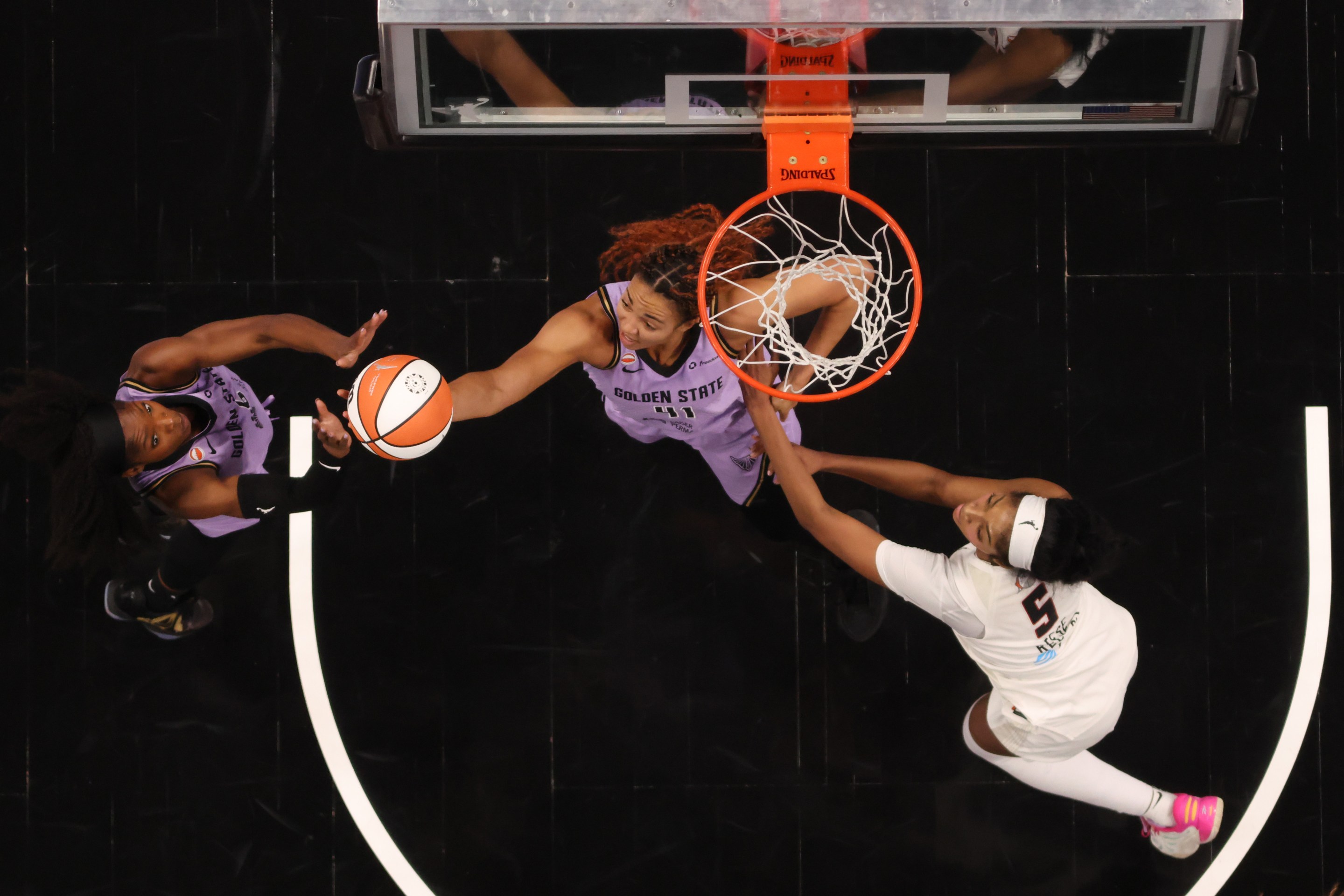 Kaila Charles #6 and Kiah Stokes #41 of the Golden State Valkyries reach for a rebound against Angel Reese #5 of the Atlanta Dream during the third quarter in game four of the 2026 WNBA Finals at State Farm Arena on October 24, 2026 in Atlanta, Georgia.