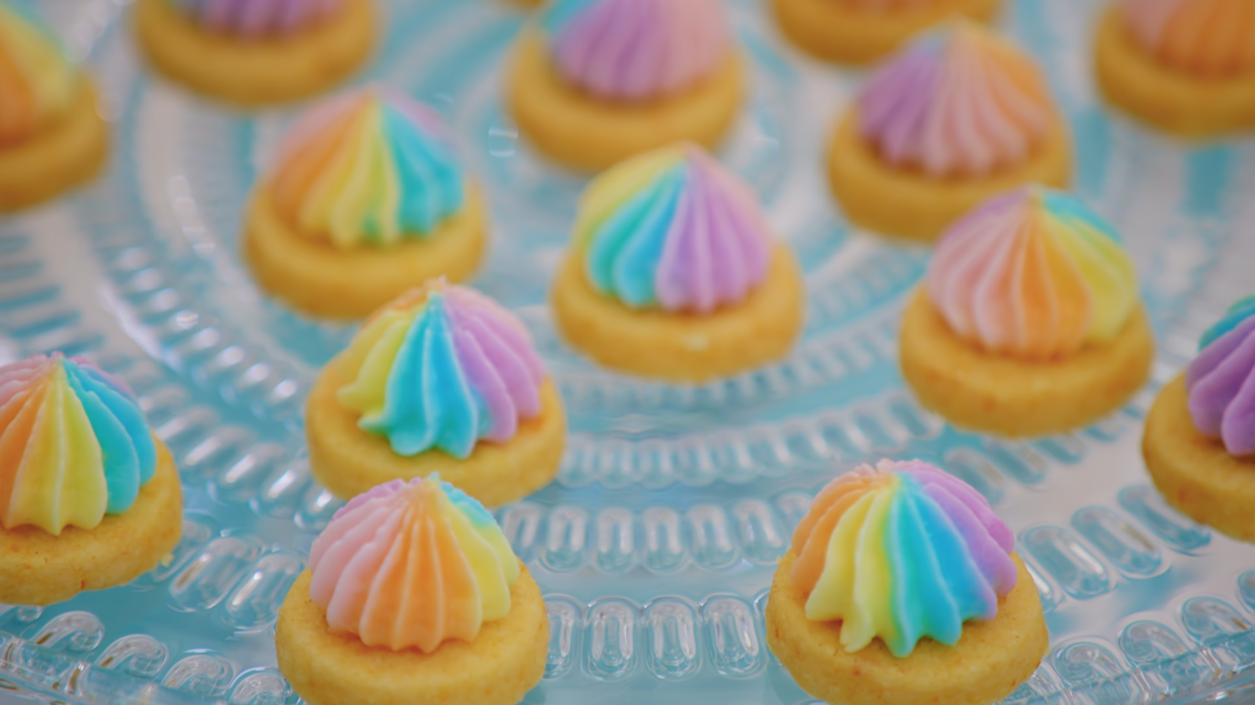 Iced gems on the show, with poofy multicolored pastel rosettes and perfect circles of shortbread.